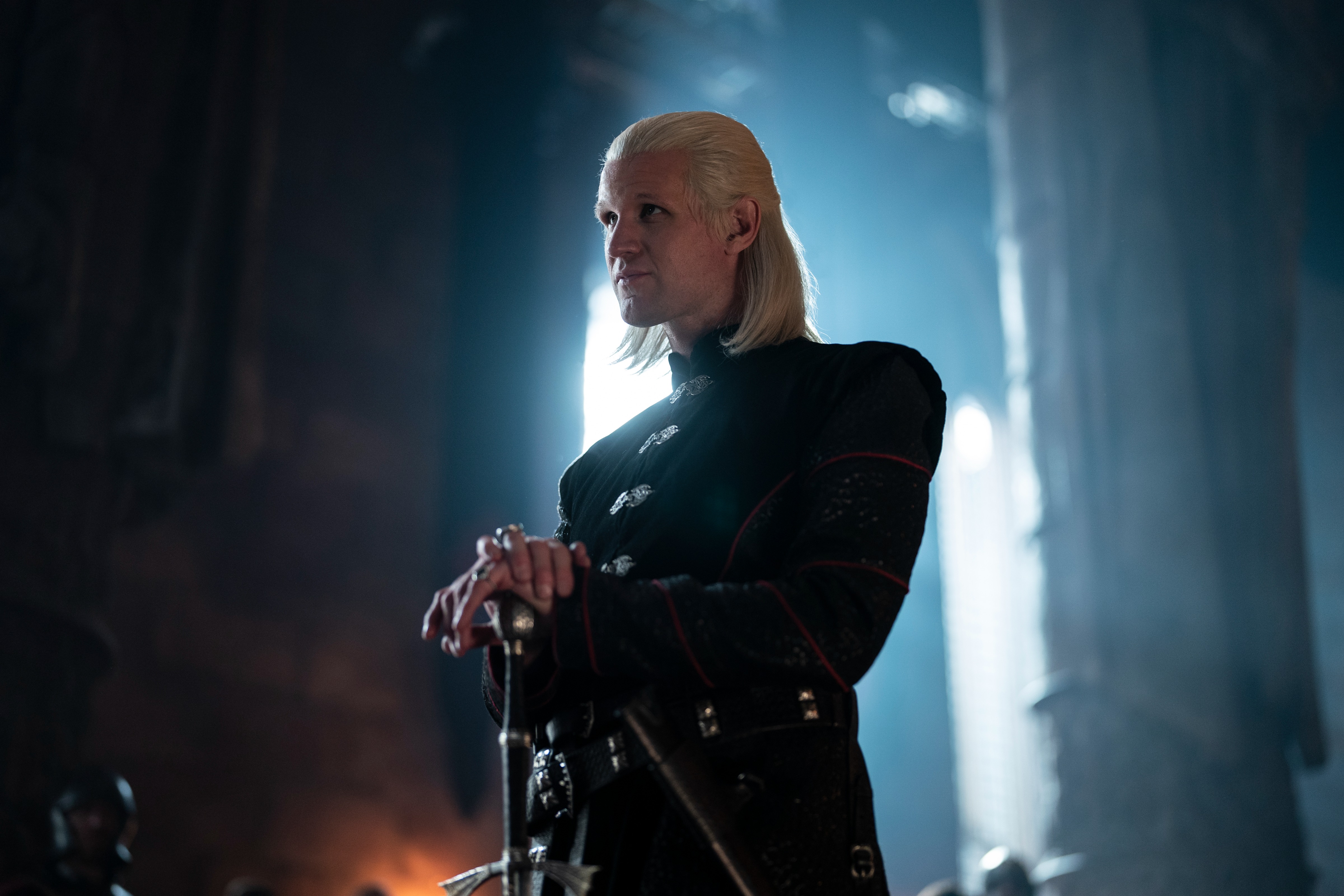 Matt Smith as Prince Daemon Targaryen standing with his hands folded atop a cane in House of the Dragon