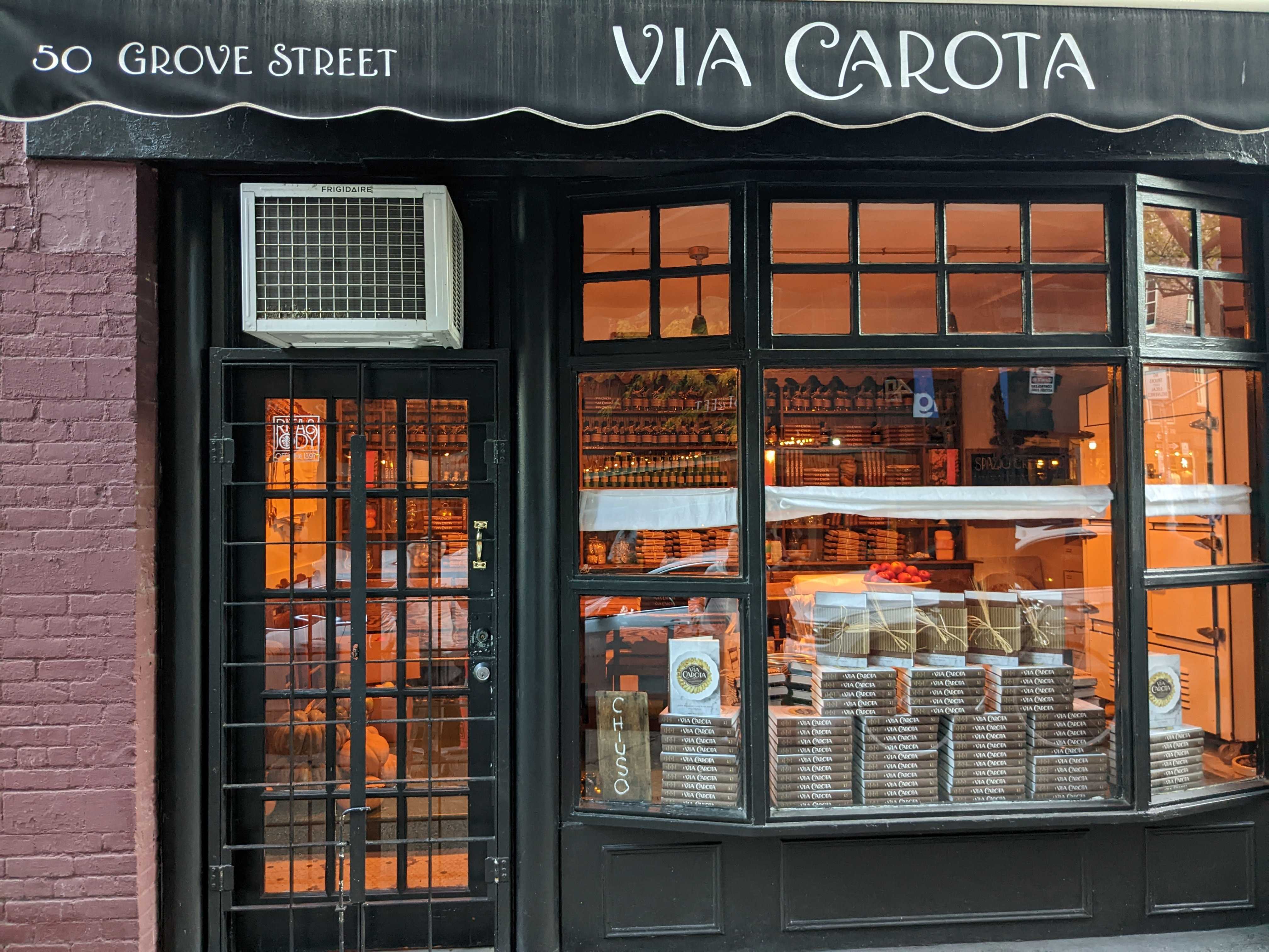 A storefront with Via Carota’s name with is displayed with the address 50 Grove Street.