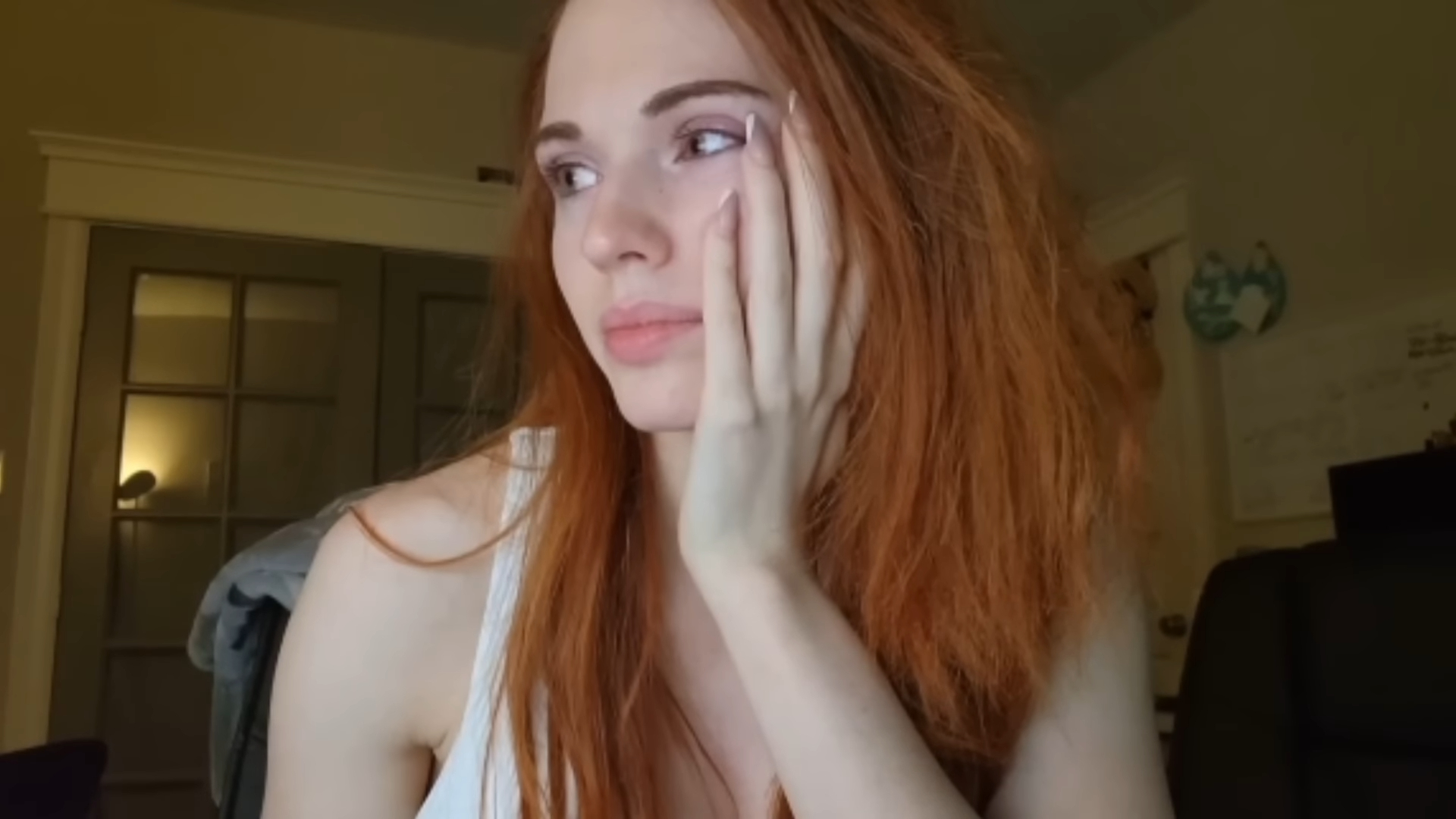 A close up image of Amouranth on a stream, looking to the left.