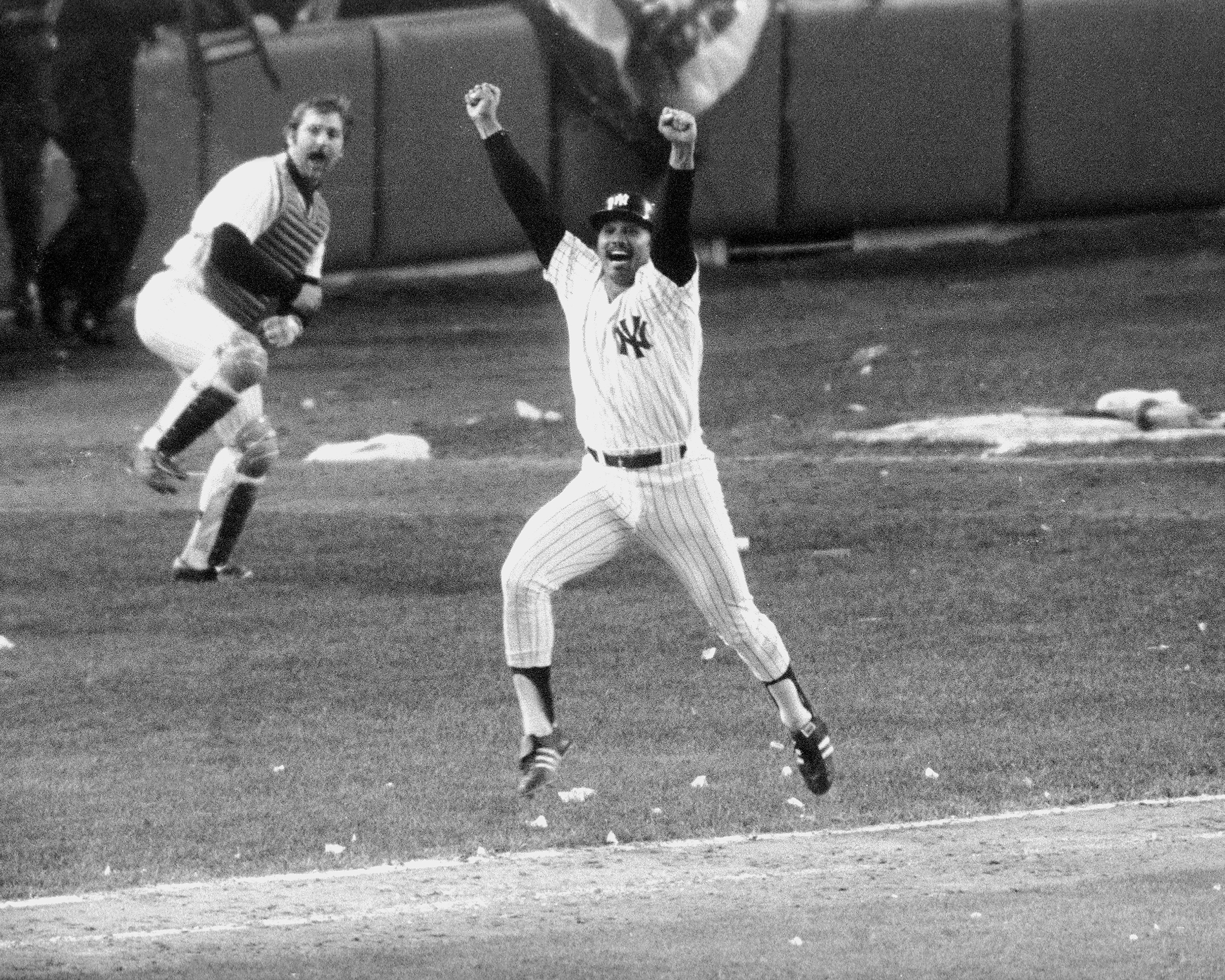 New York Yankees’ Chris Chambliss jumps for joy after connec