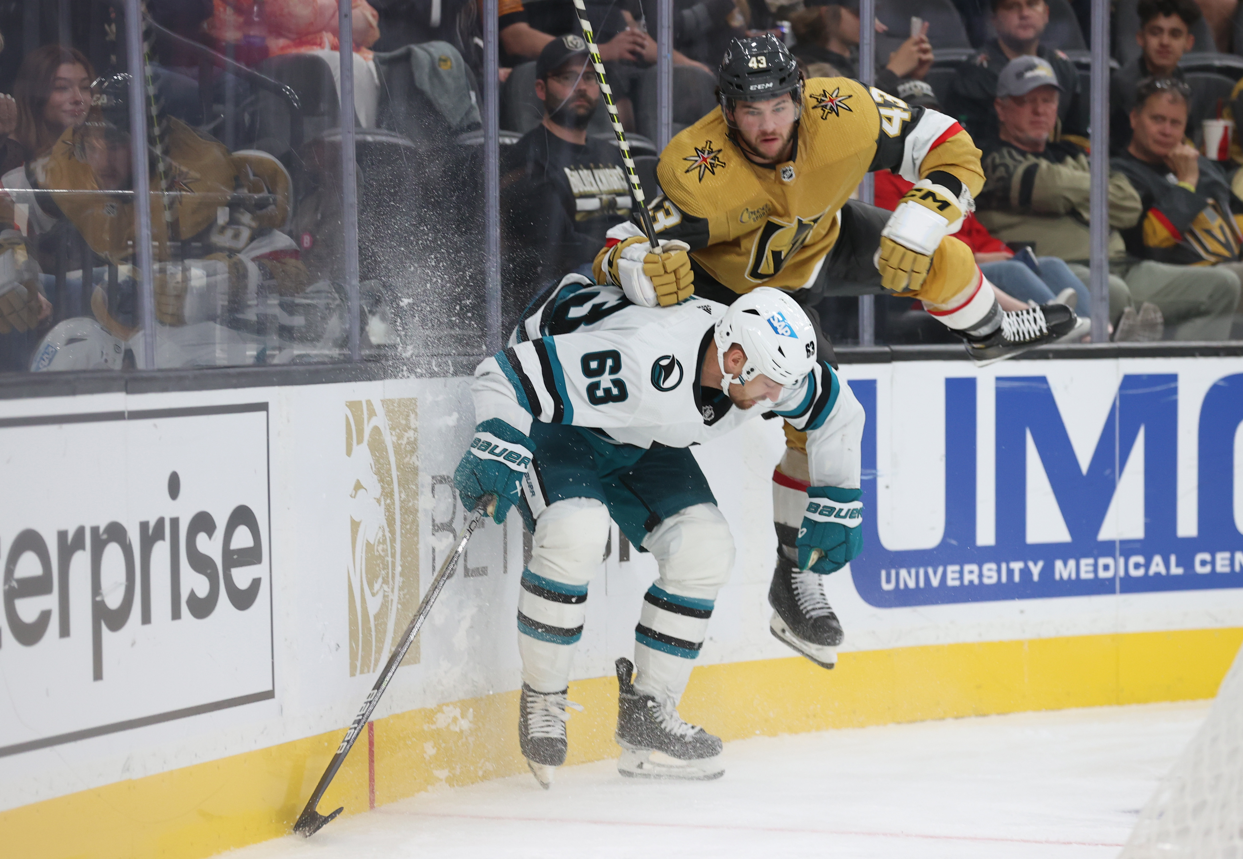 Jeffrey Viel #63 of the San Jose Sharks hits Paul Cotter #43 of the Vegas Golden Knights during the third period in a preseason game at T-Mobile Arena on September 30, 2022 in Las Vegas, Nevada.