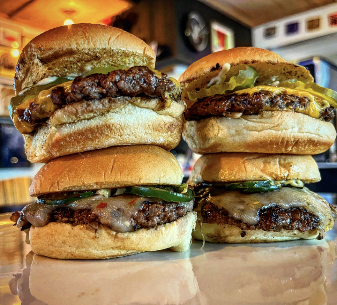 Two stacks of two slider burgers.