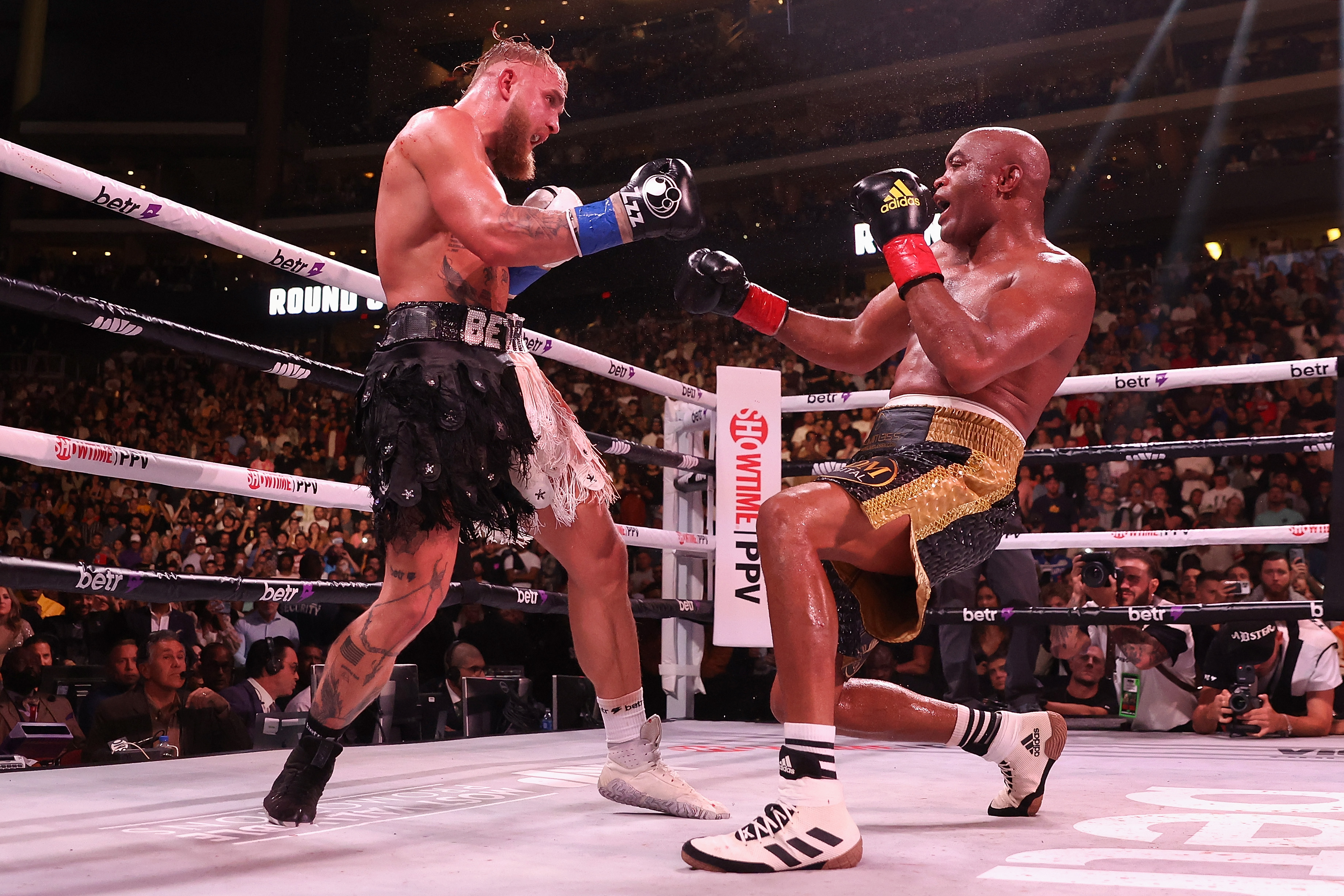 Jake Paul knocks down Anderson Silva during their boxing match on Saturday. 