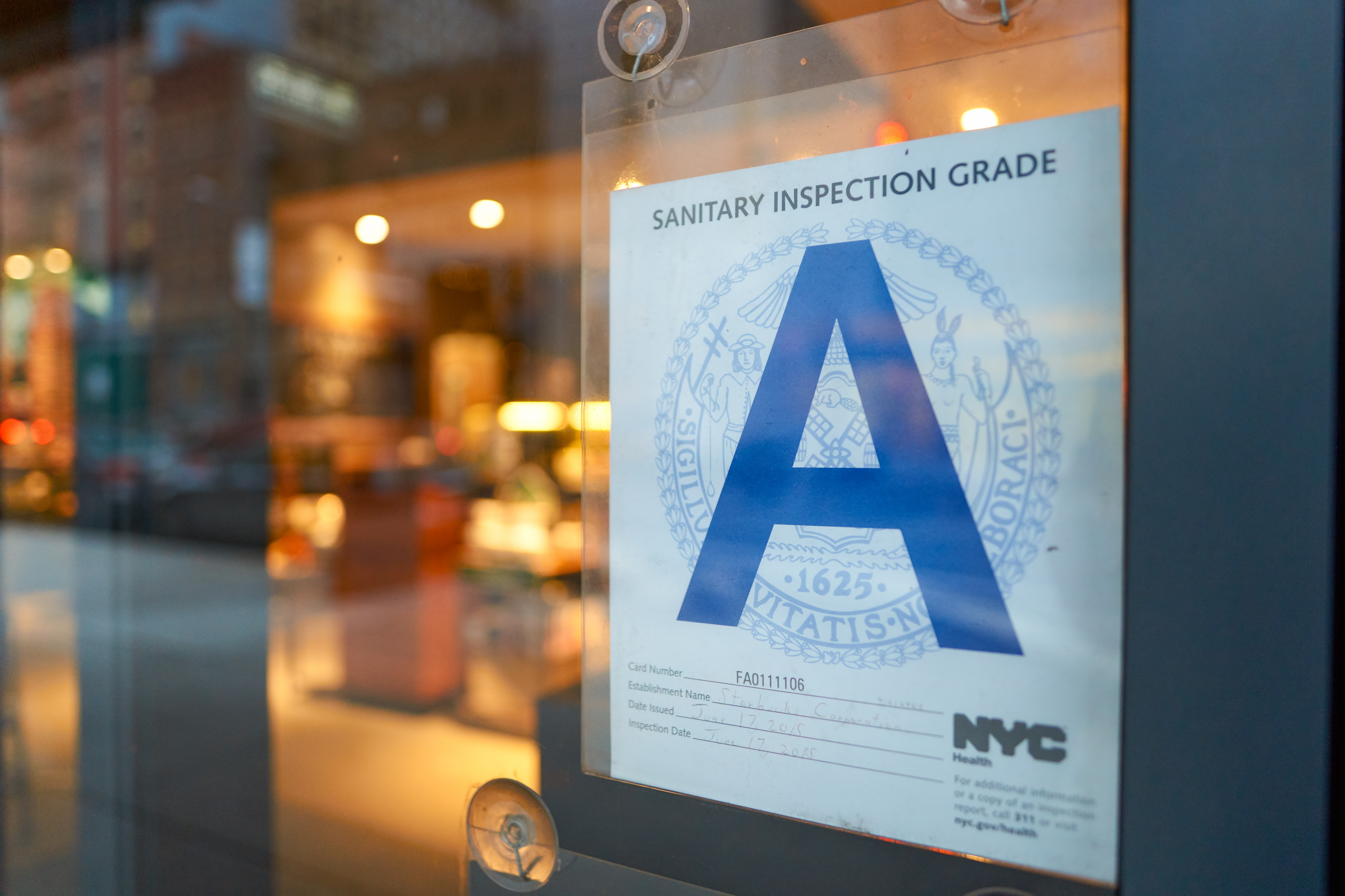 The blue letter grade of a NYC Health Department inspection is posted to a restaurant window. The Detroit City Council rejected a proposal Tuesday that would have required restaurants to post a color-coded sign to inform diners of the results of their health department inspections.