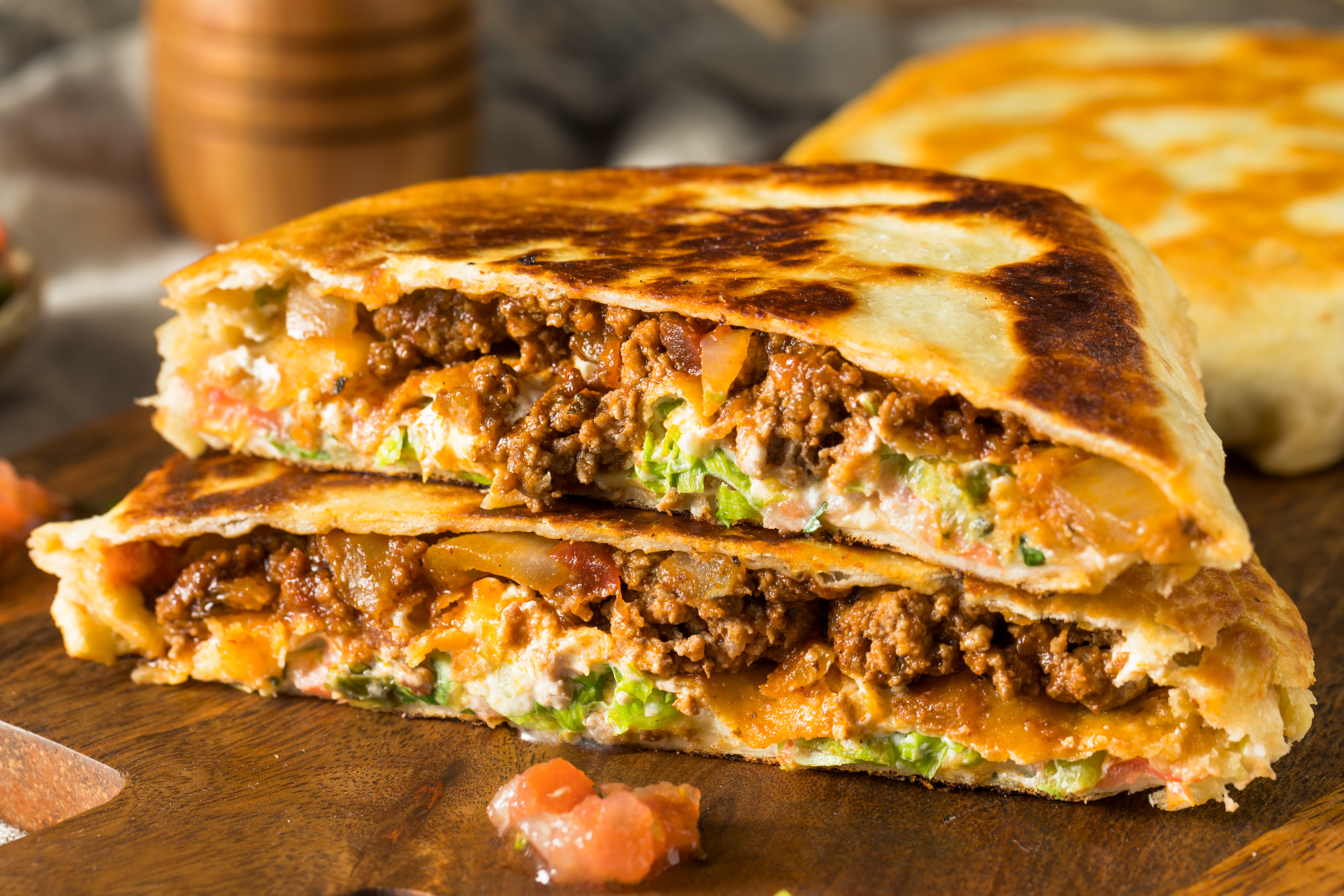 A Crunchwrap cut in half and stacked.