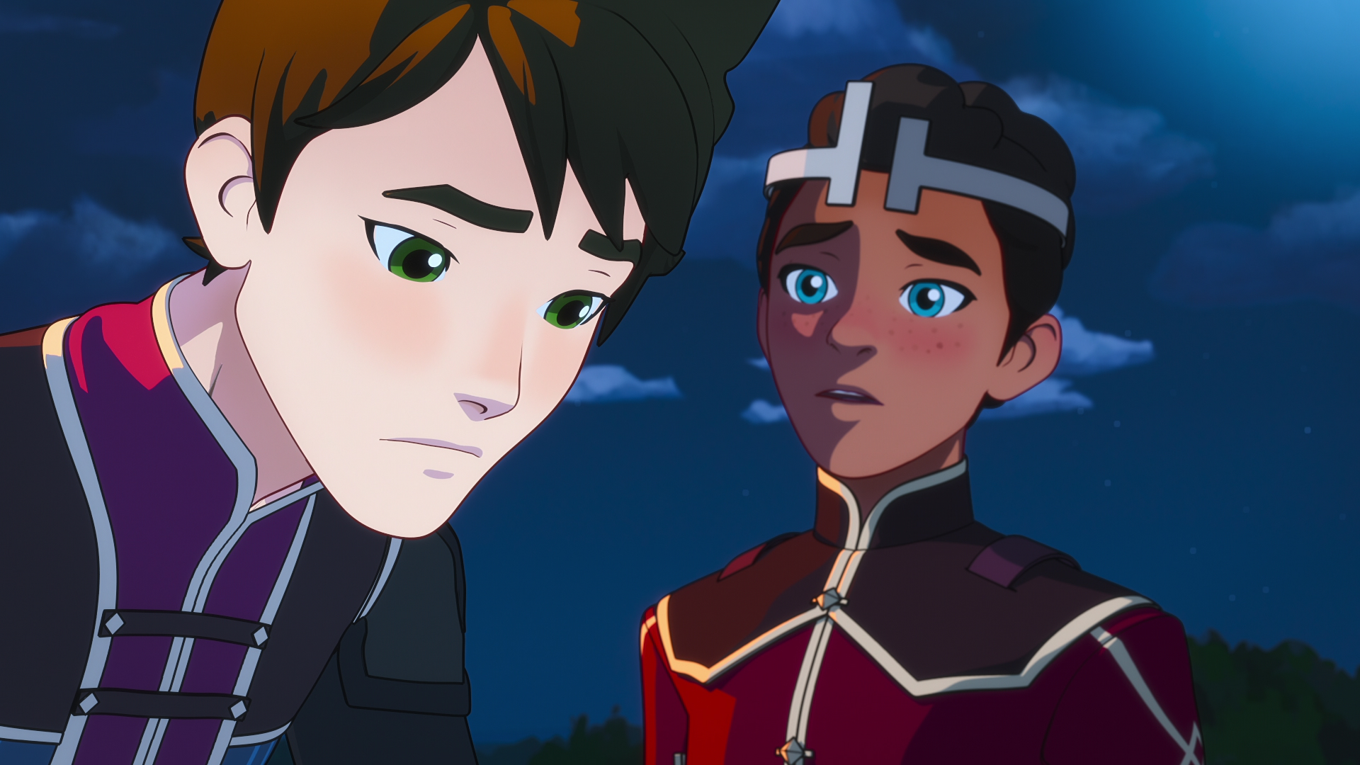ezran, a young boy with light brown skin and curly dark hair wearing a crown, stands next to his brother callum, a paler boy with dark hair. callum slouches forward, frowning. ezran looks concerned. it is night time behind them.