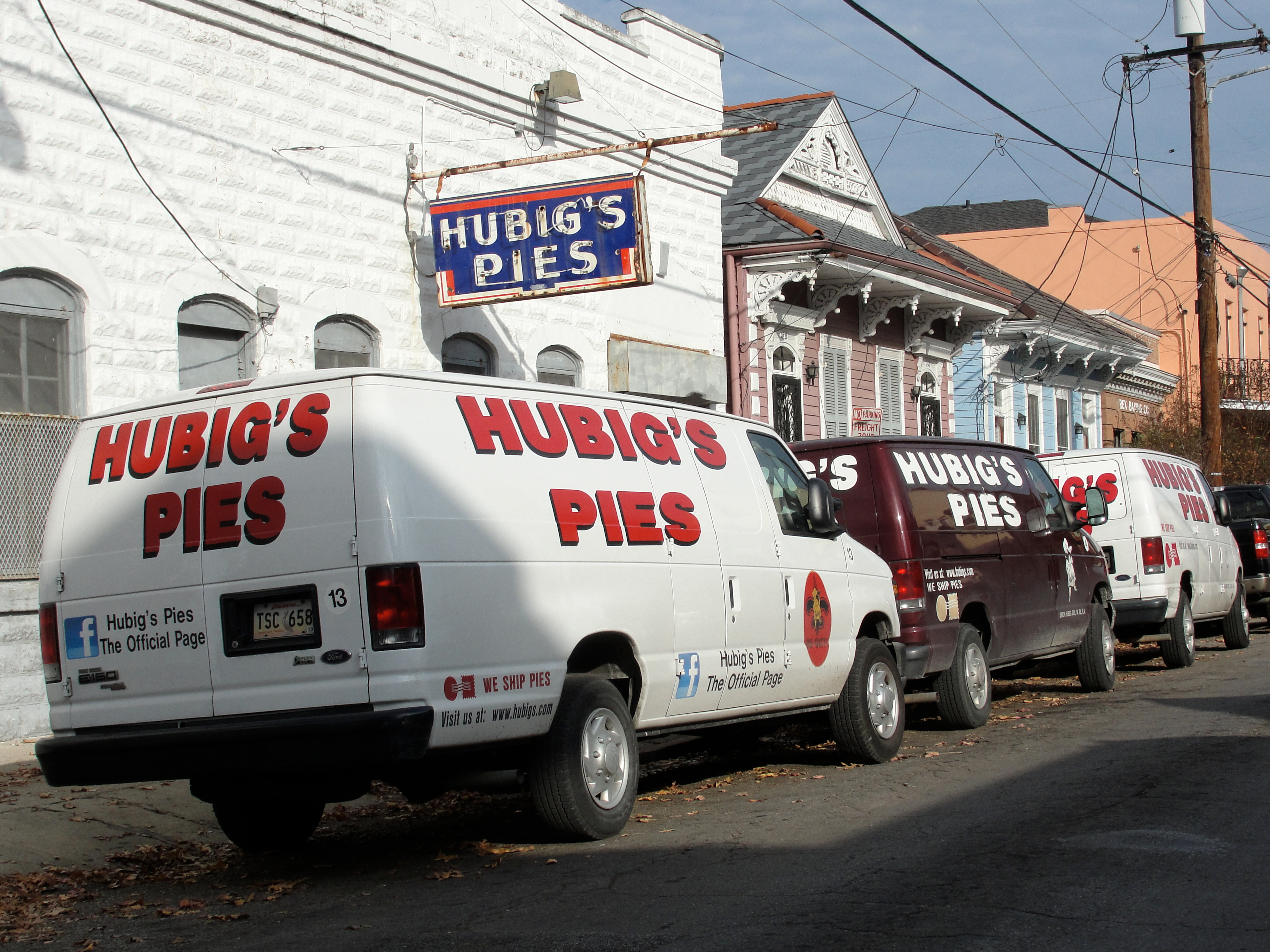 Two Hubig’s Pies-branded vans are parked outside of the company’s former production facility in the Marigny.