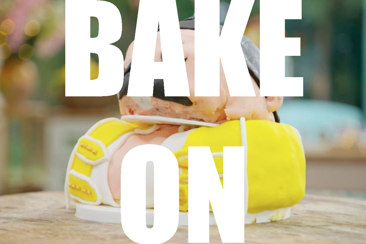 A photo of a cake that is meant to resemble Freddie Mercury in a yellow jacket. The words BAKE ON are superimposed over the photo in white text.