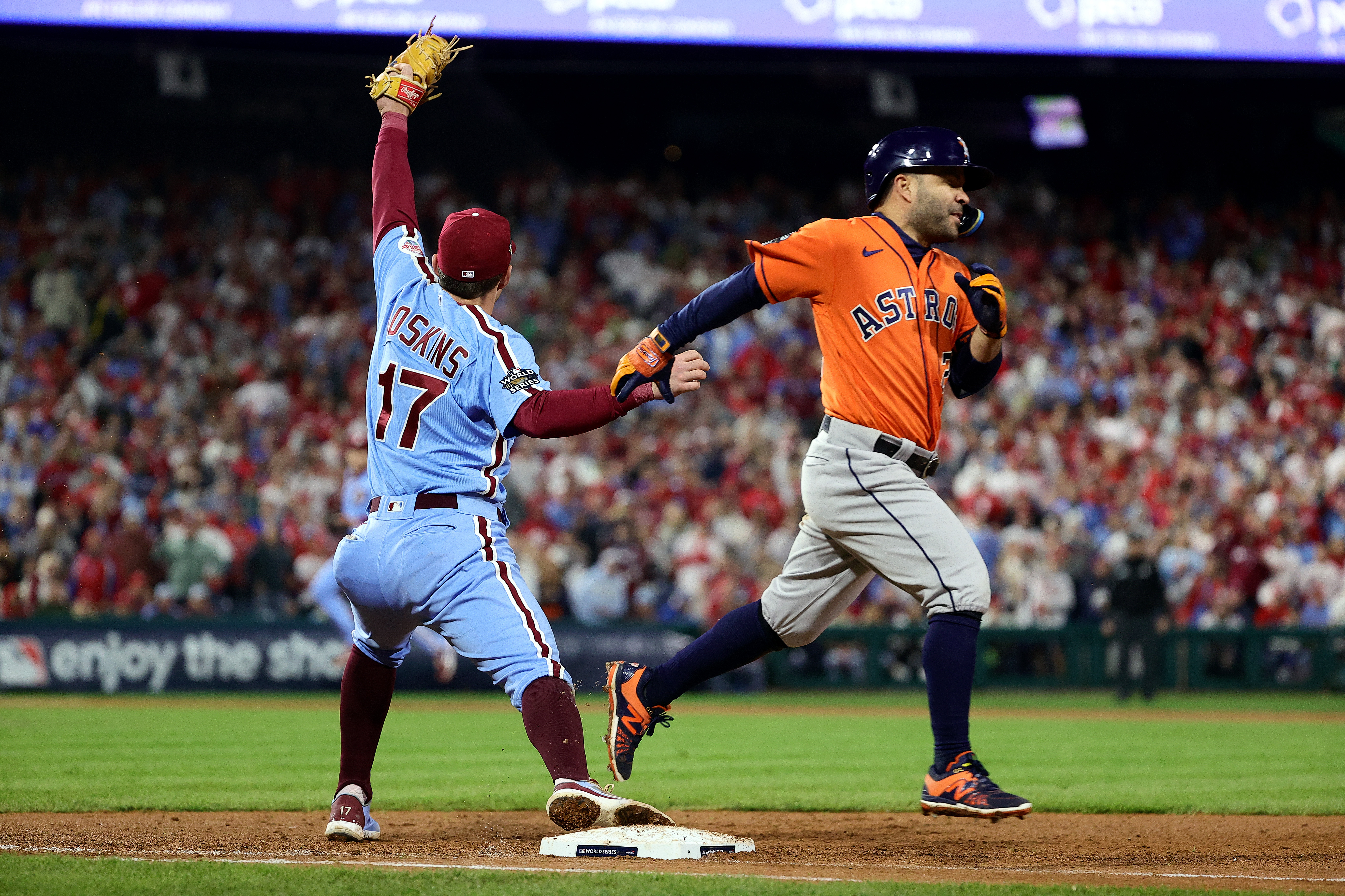 PHILADELPHIA, PENNSYLVANIA - NOVEMBER 03: Jose Altuve #27 of the Houston Astros is forced out at first base by Rhys Hoskins #17 of the Philadelphia Phillies during the ninth inning in Game Five of the 2022 World Series at Citizens Bank Park on November 03, 2022 in Philadelphia, Pennsylvania.