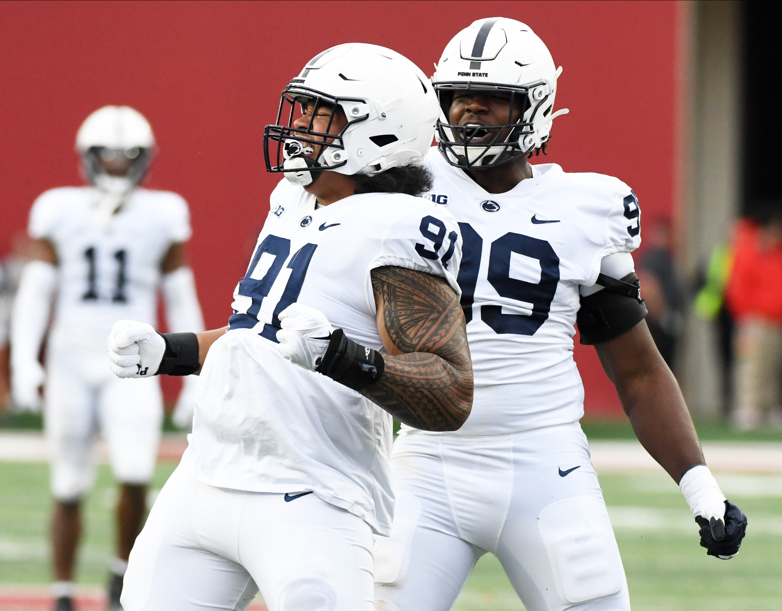 Nov 5, 2022; Bloomington, Indiana, USA; Penn State Nittany Lions defensive tackle Dvon Ellies (91) celebrates with Penn State Nittany Lions defensive tackle Coziah Izzard (99) after a sack during the first half at Memorial Stadium.