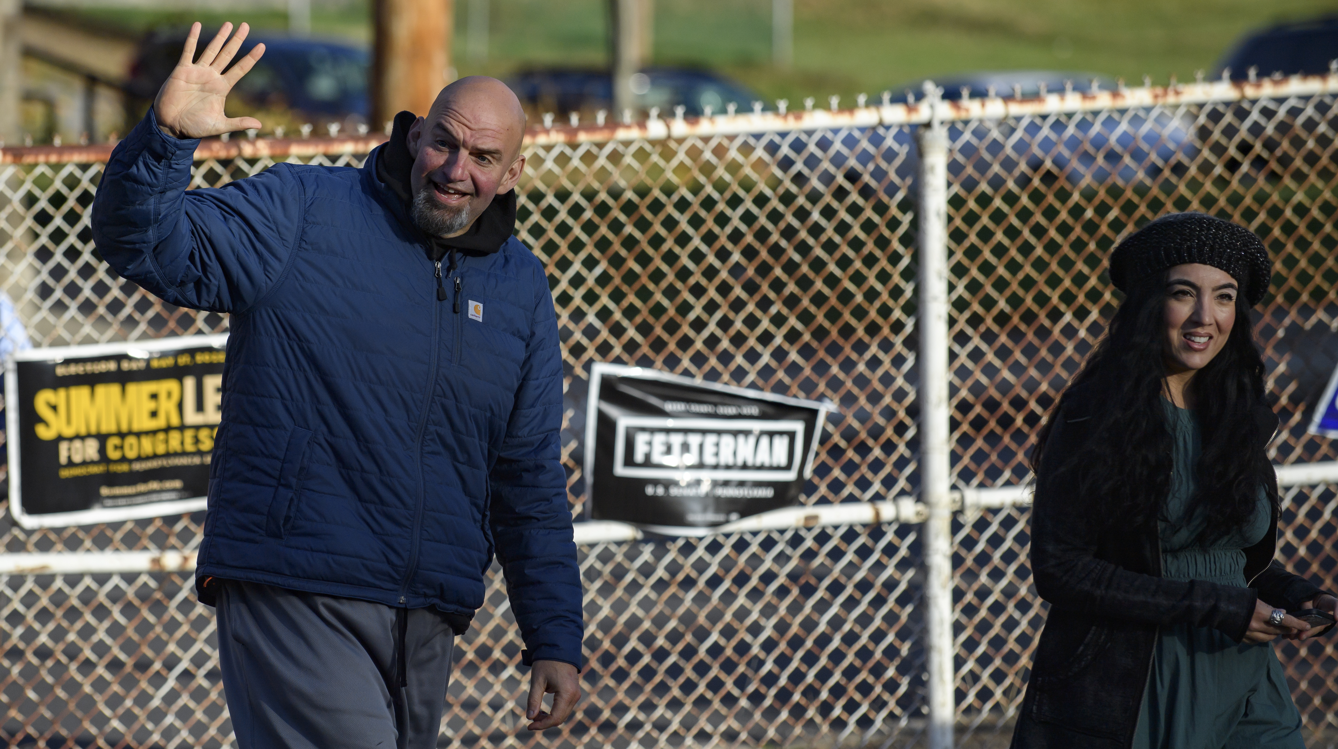 Pennsylvania Democratic Senate candidate John Fetterman and his wife, Gisele, walk into their polling place to cast their votes at the New Hope Baptist Church on November 8, 2022 in Braddock, Pennsylvania.