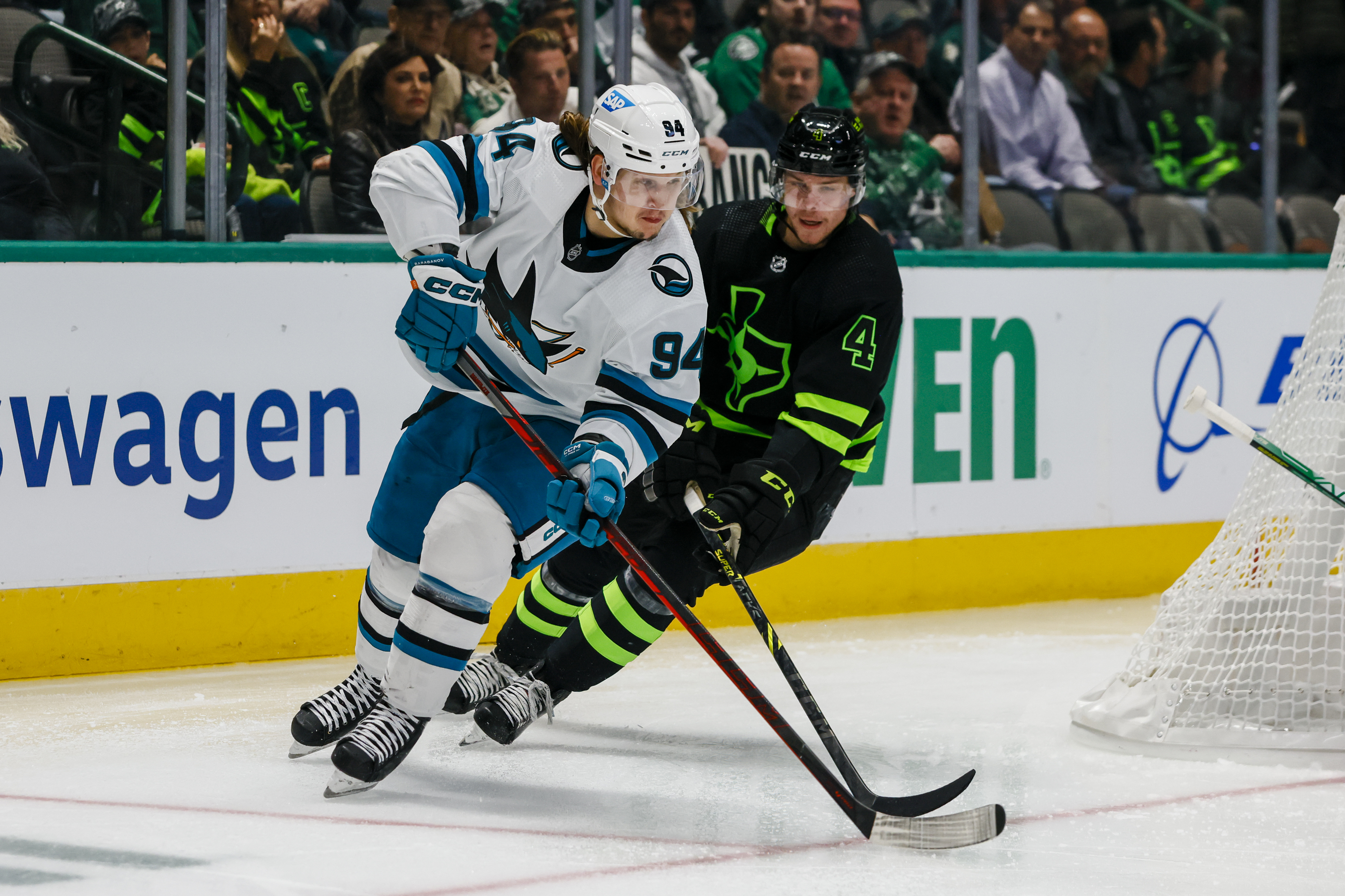 San Jose Sharks left wing Alexander Barabanov (94) and Dallas Stars defenseman Miro Heiskanen (4) chase the puck during the game between the Dallas Stars and the San Jose Sharks on November 11, 2022 at American Airlines Center in Dallas, Texas.
