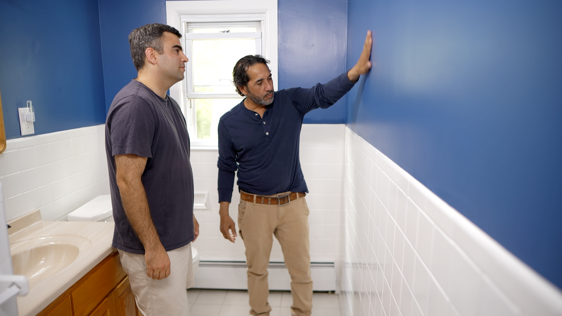 S21 E7, Mauro Henrique paints a tile bathroom wall