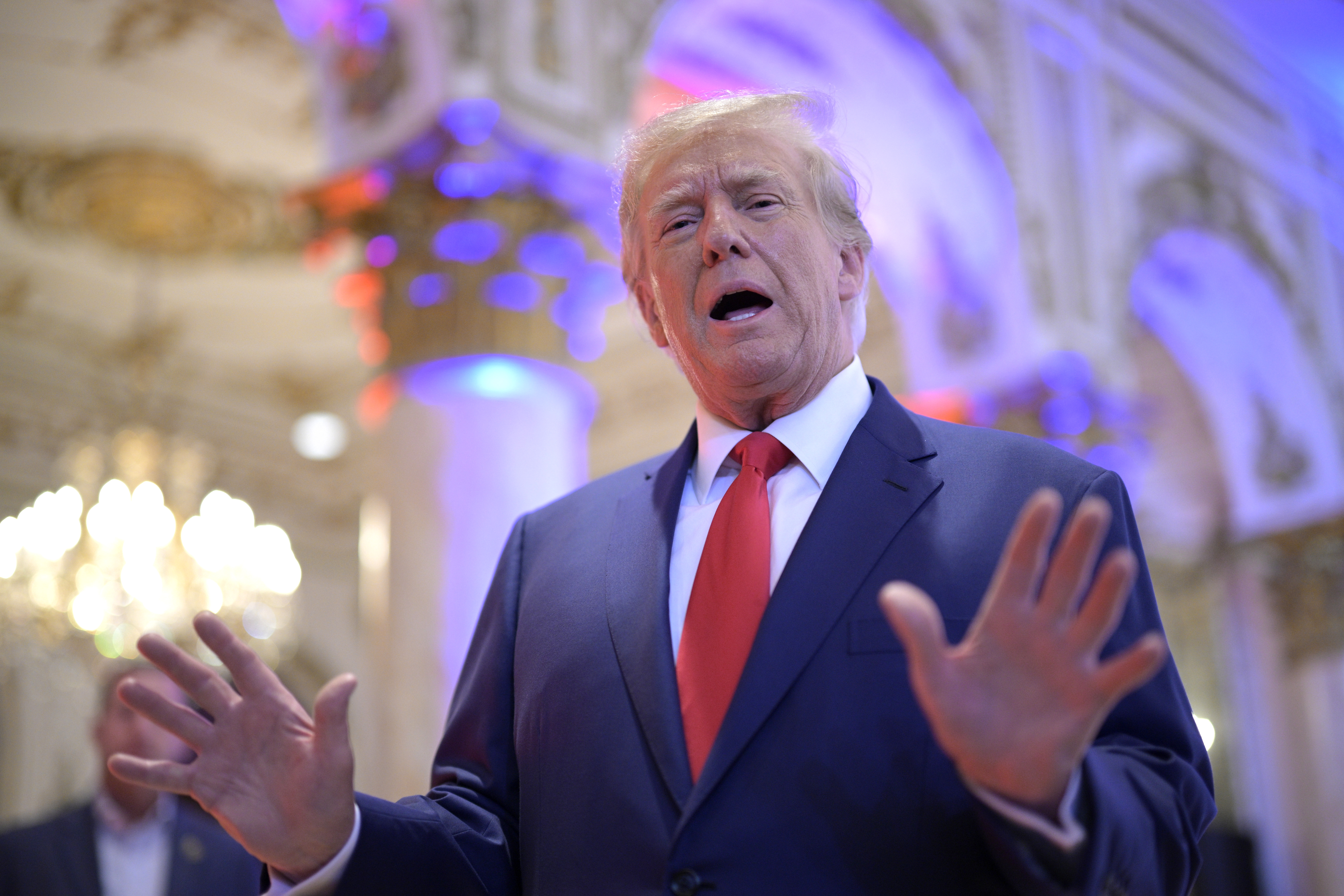 Former President Donald Trump answers questions from reporters during an election night party at Mar-a-Lago, Tuesday, November 8, 2022 in Palm Beach, Florida.
