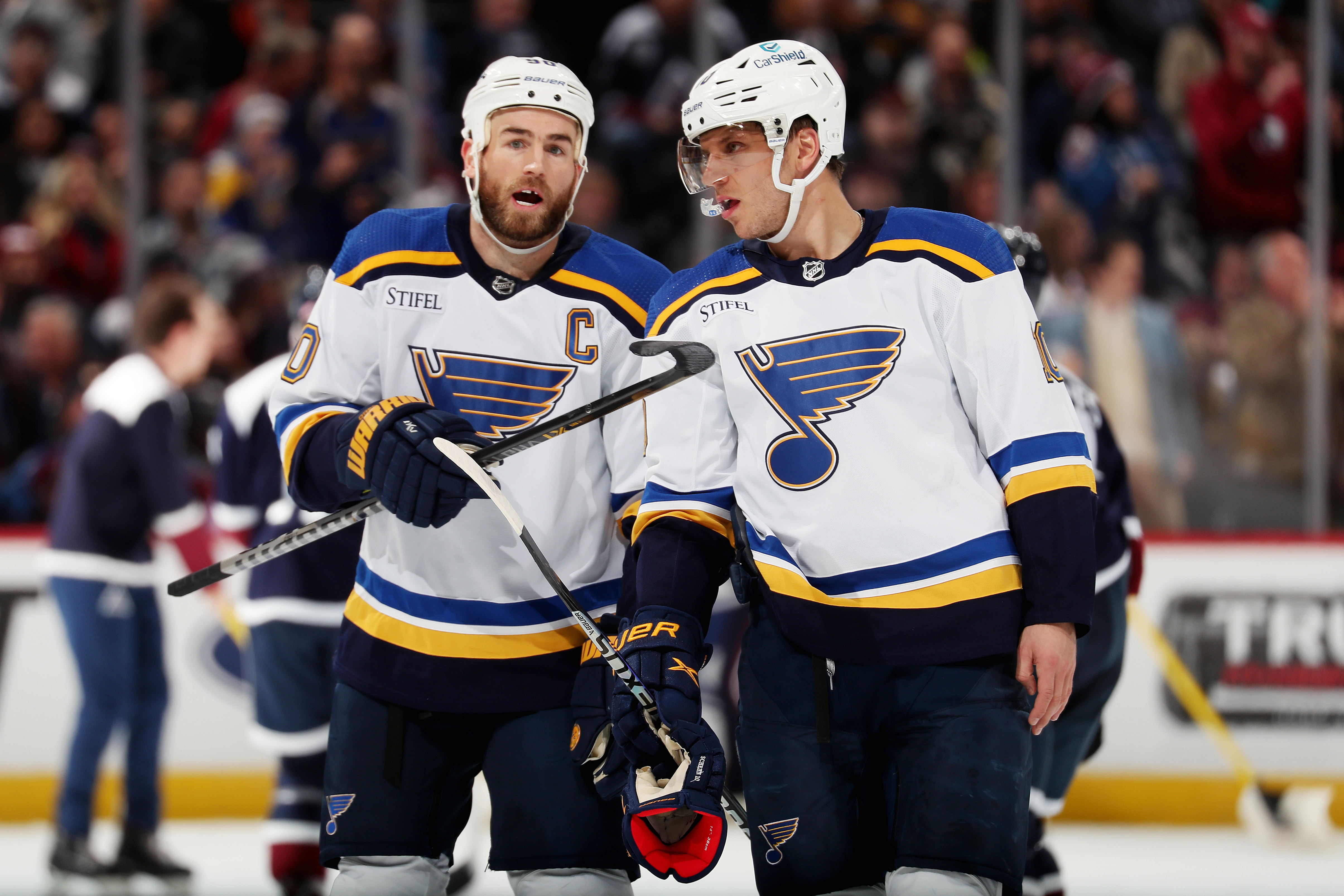 Ryan O’Reilly and Brayden Schenn of the St. Louis Blues converse during a pause in play against the Colorado Avalanche at Ball Arena on November 14, 2022 in Denver, Colorado.