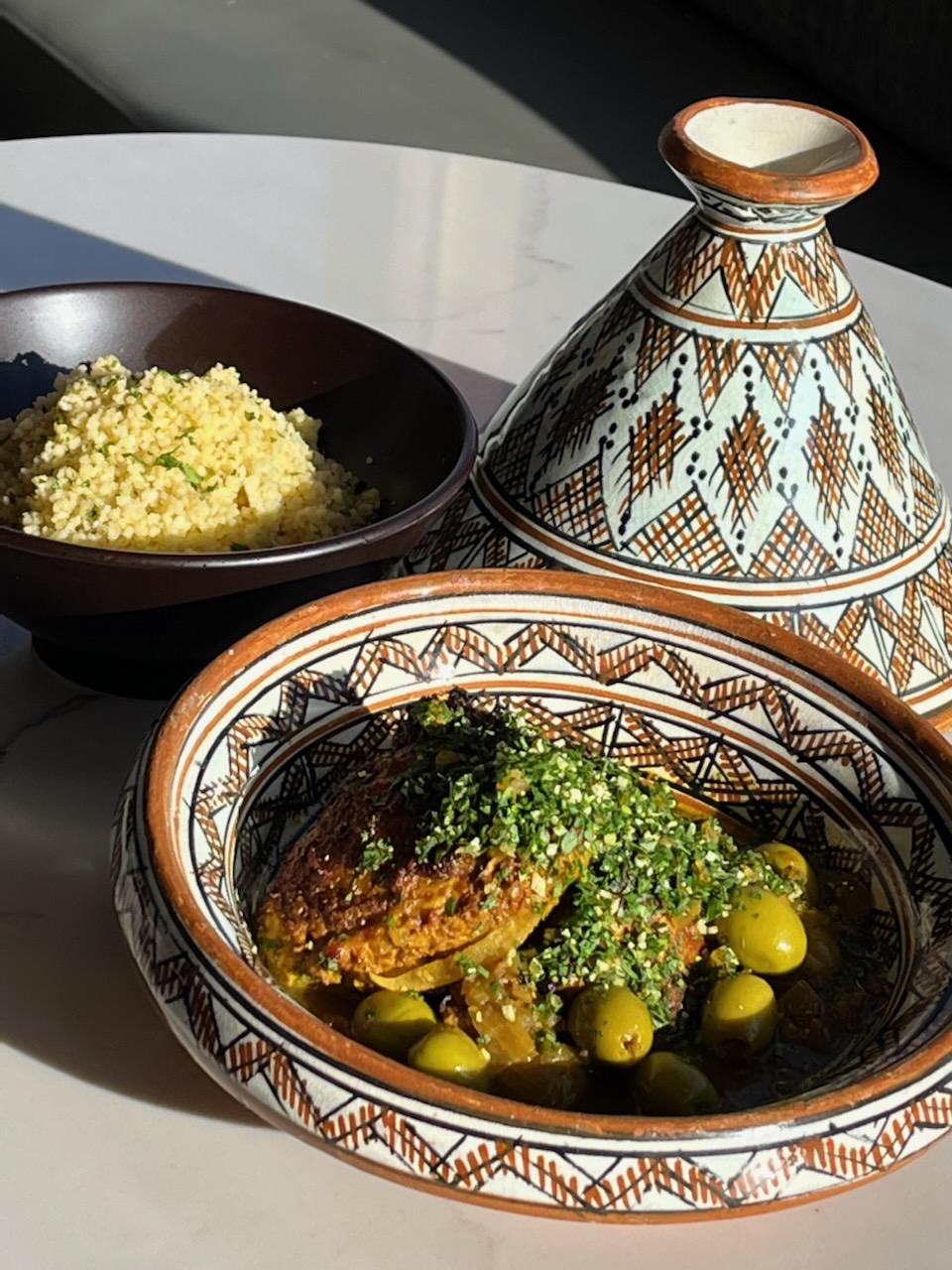 A decorated tagine and bowl of chicken tagine.