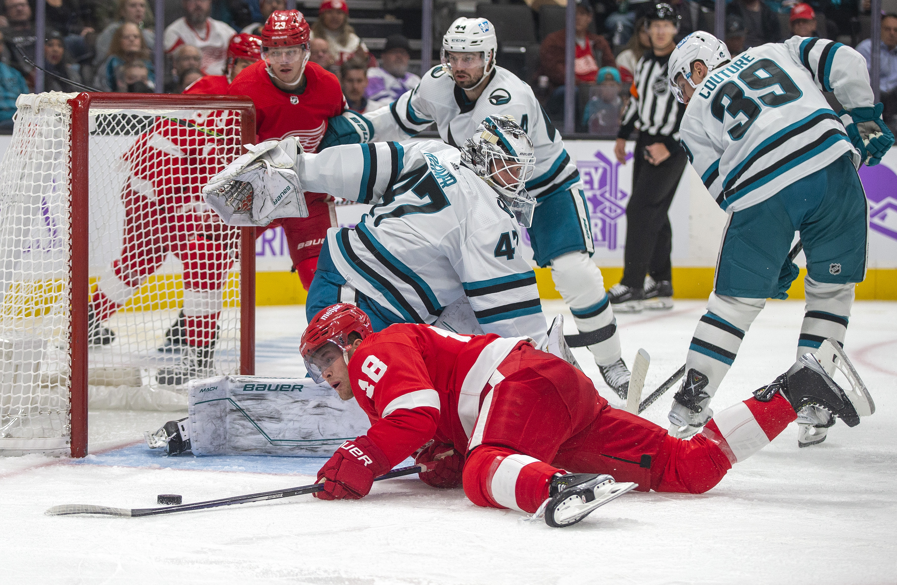 SAN JOSE, CA - NOVEMBER 17: Detroit Red Wings Center Andrew Copp (18) tries to move the puck past San Jose Sharks Goalie James Reimer (47) into the goal during the third period of a regular season NHL hockey game between the Detroit Red Wings and the San Jose Sharks on November 17, 2022, at SAP Center, in San Jose, CA.