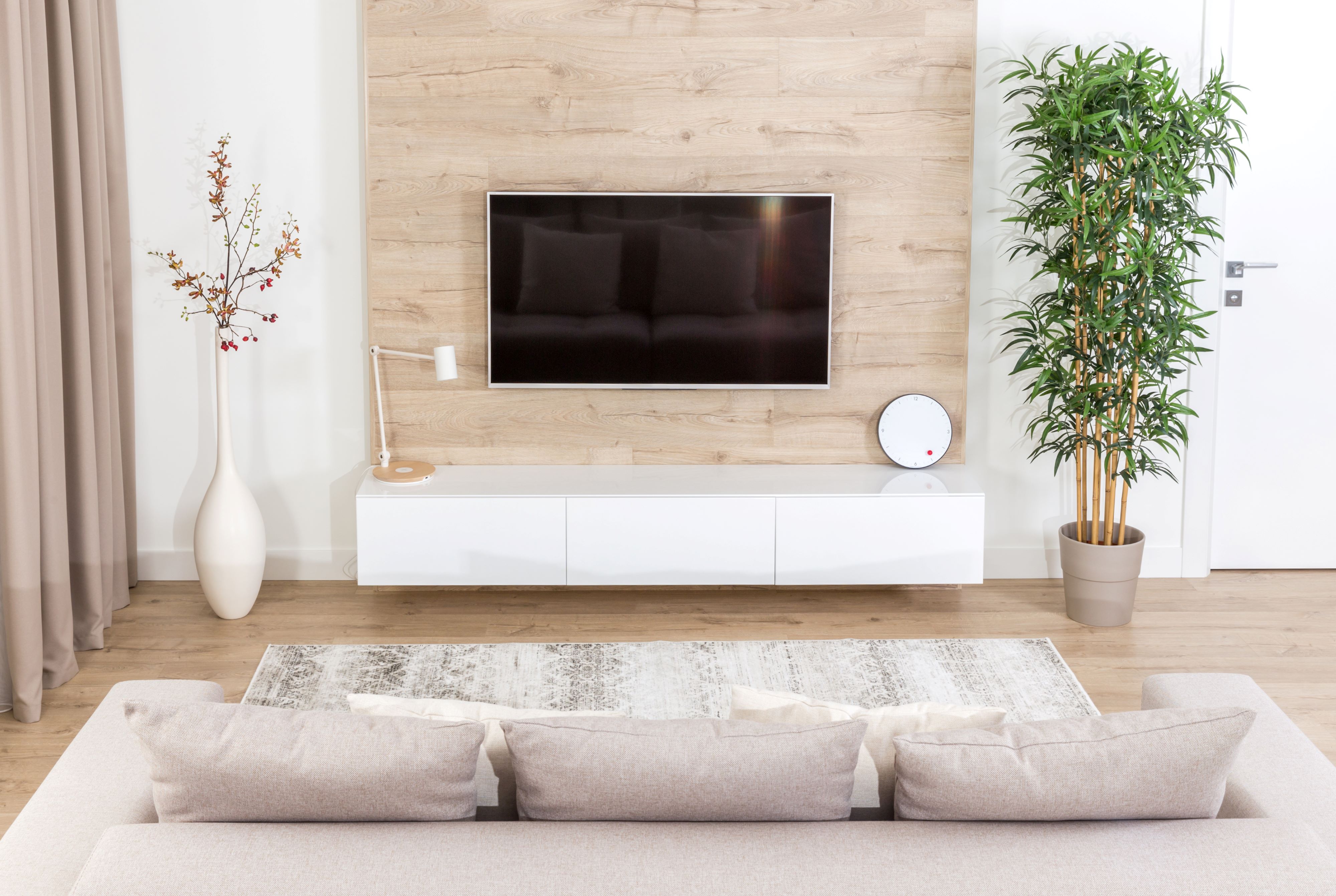 a 40-inch smart TV mounted on the wall in a small modern living room
