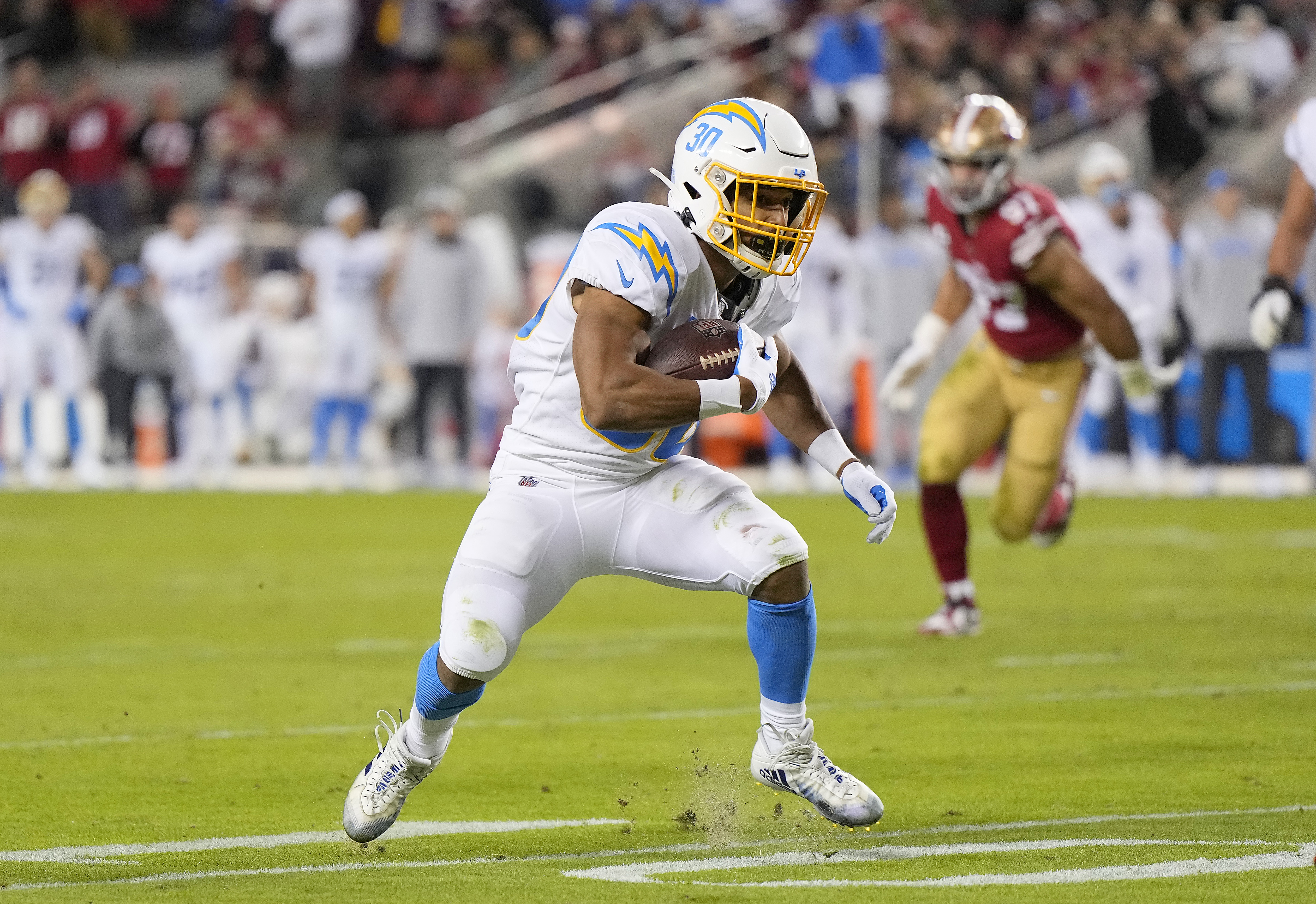 Austin Ekeler #30 of the Los Angeles Chargers runs with the ball during the second quarter against the San Francisco 49ers at Levi’s Stadium on November 13, 2022 in Santa Clara, California.