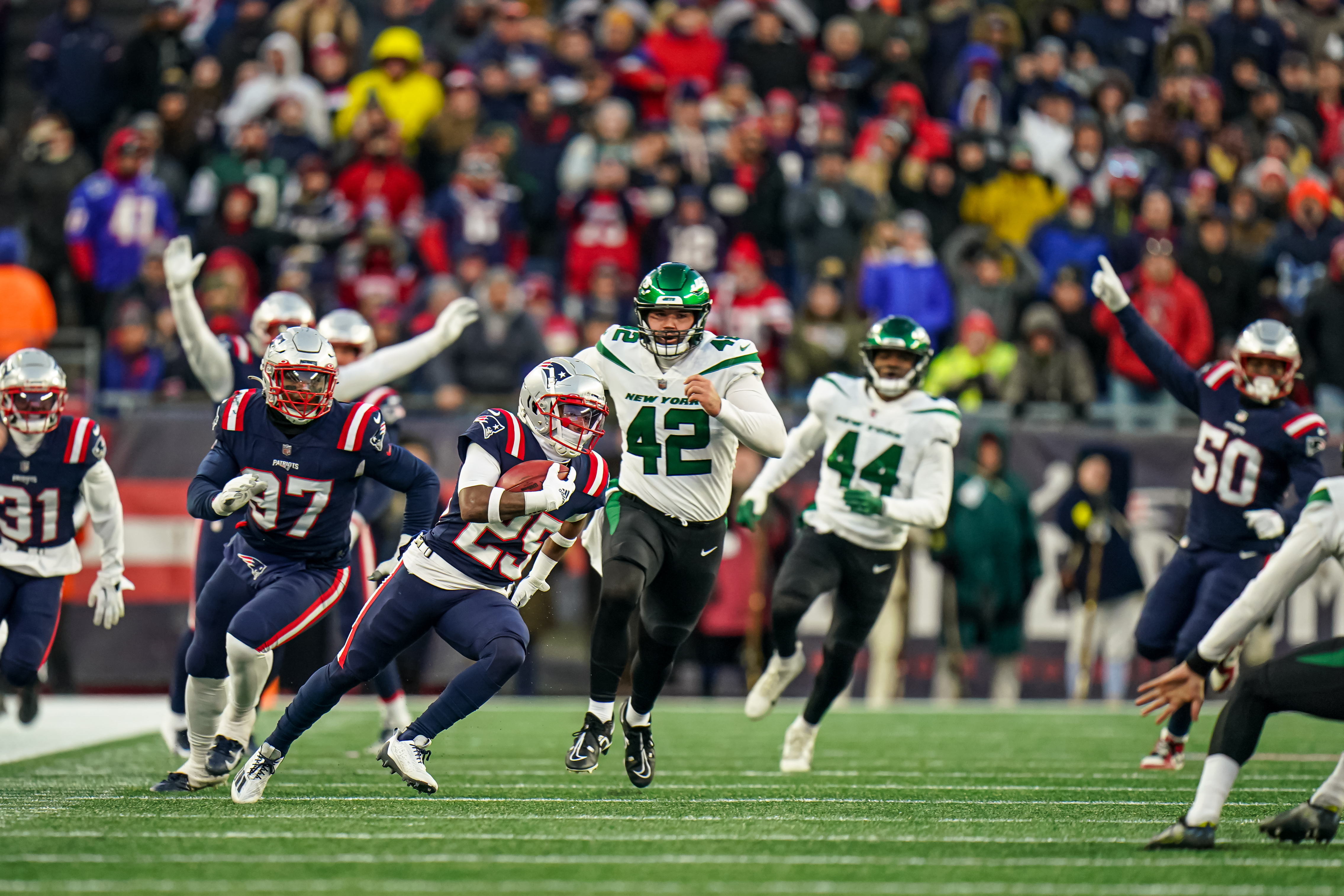 New England Patriots special teams Marcus Jones (25) returns the kick for a touchdown to win the game against the New York Jets in the second half at Gillette Stadium.