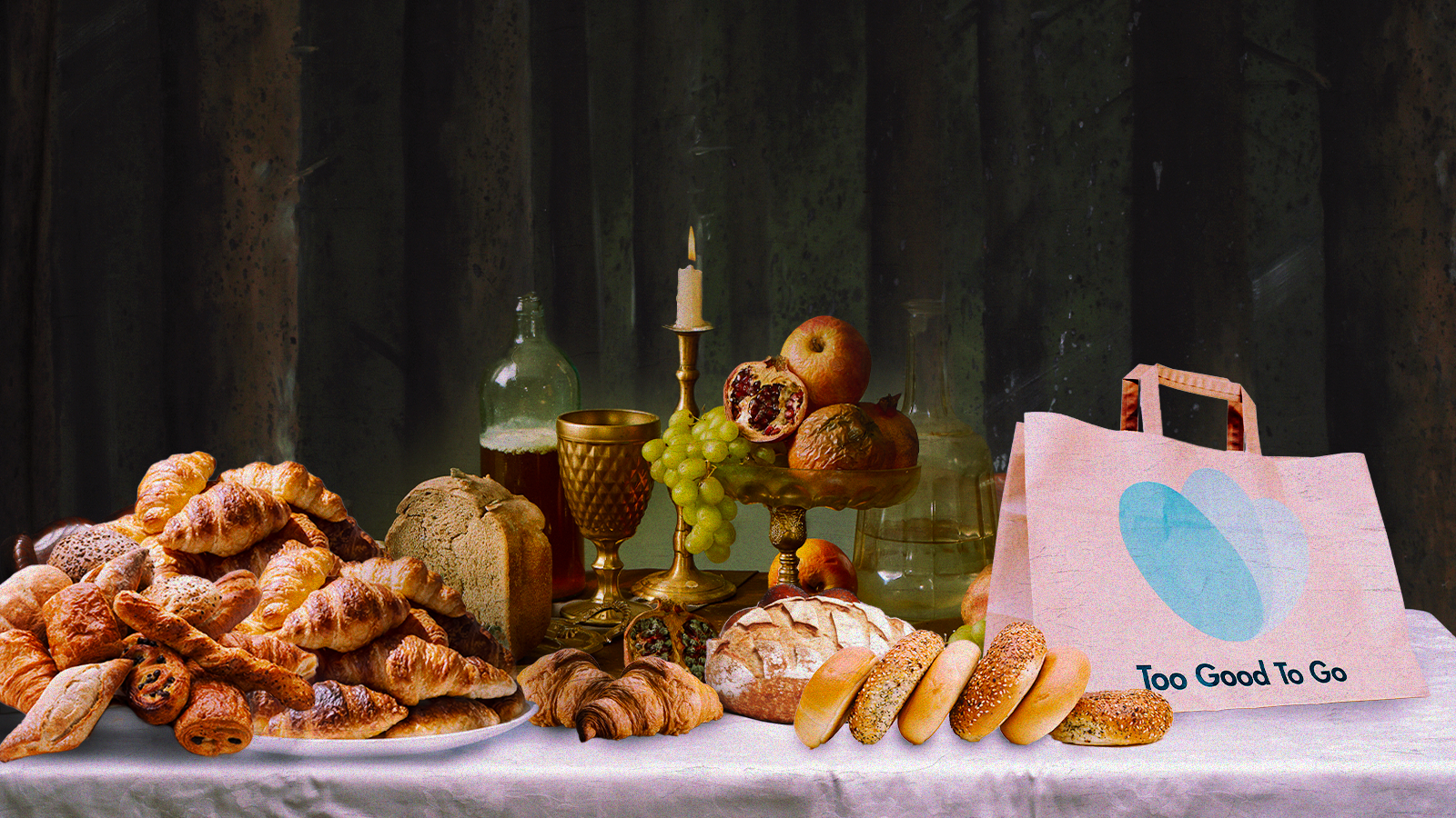 Renaissance-style painting of a tablescape with fruit and cakes, with a pile of bagels, pastries, and a bag with “Too Good To Go” written on it photo-imposed on top.