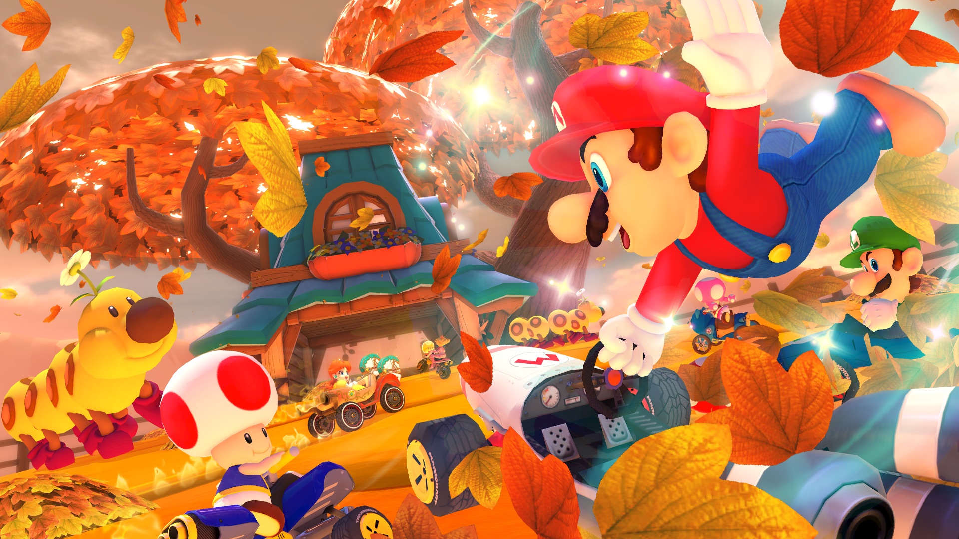 Mario pulls off a stunt on his kart while Toad, Luigi, and Daisy (and a Wiggler) look on in a screenshot of Mario Kart 8 Deluxe’s version of the Maple Treeway course