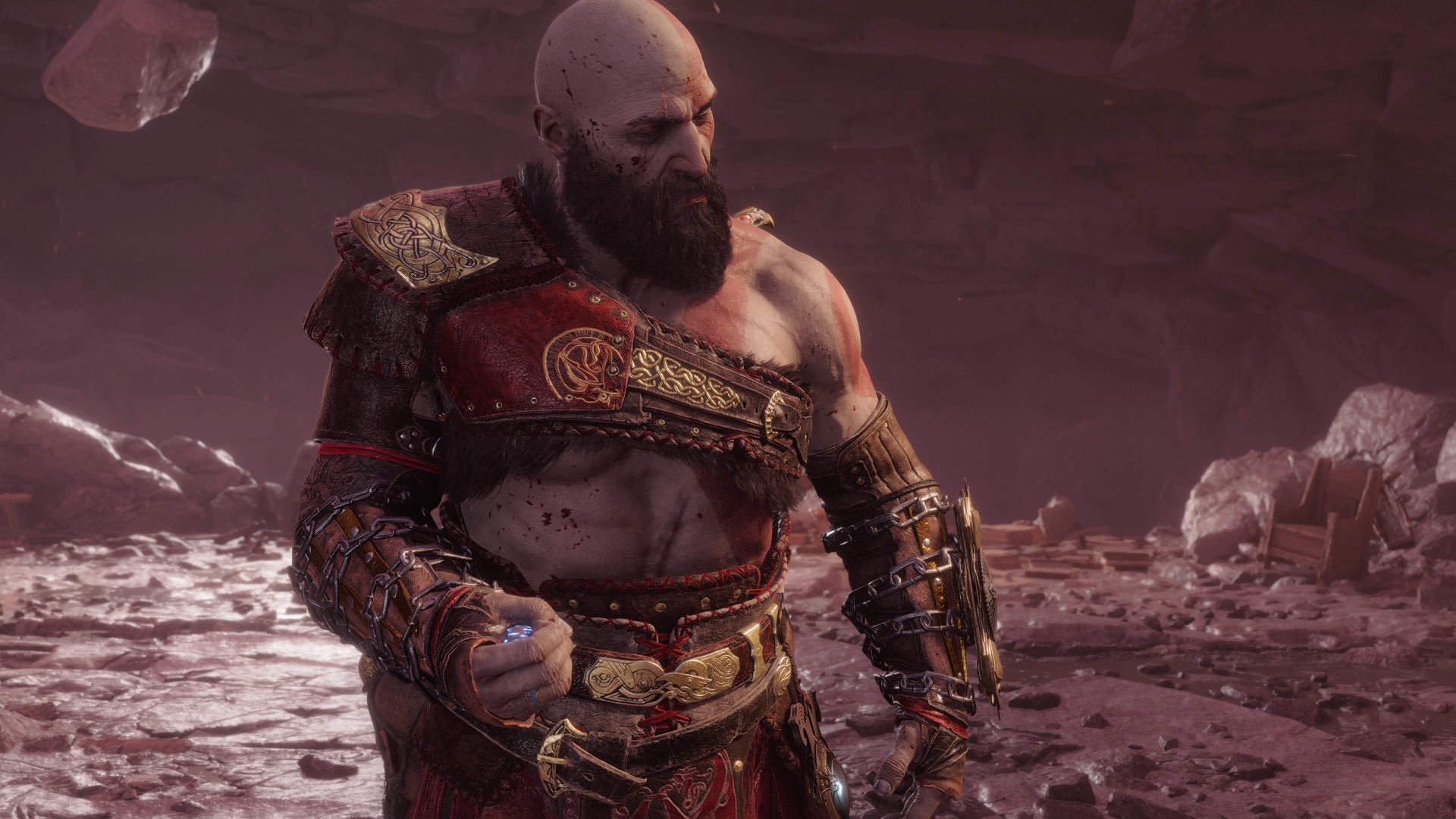 Kratos stands somberly as Asgard falls to ruin around him in the end of God of War Ragnarok.