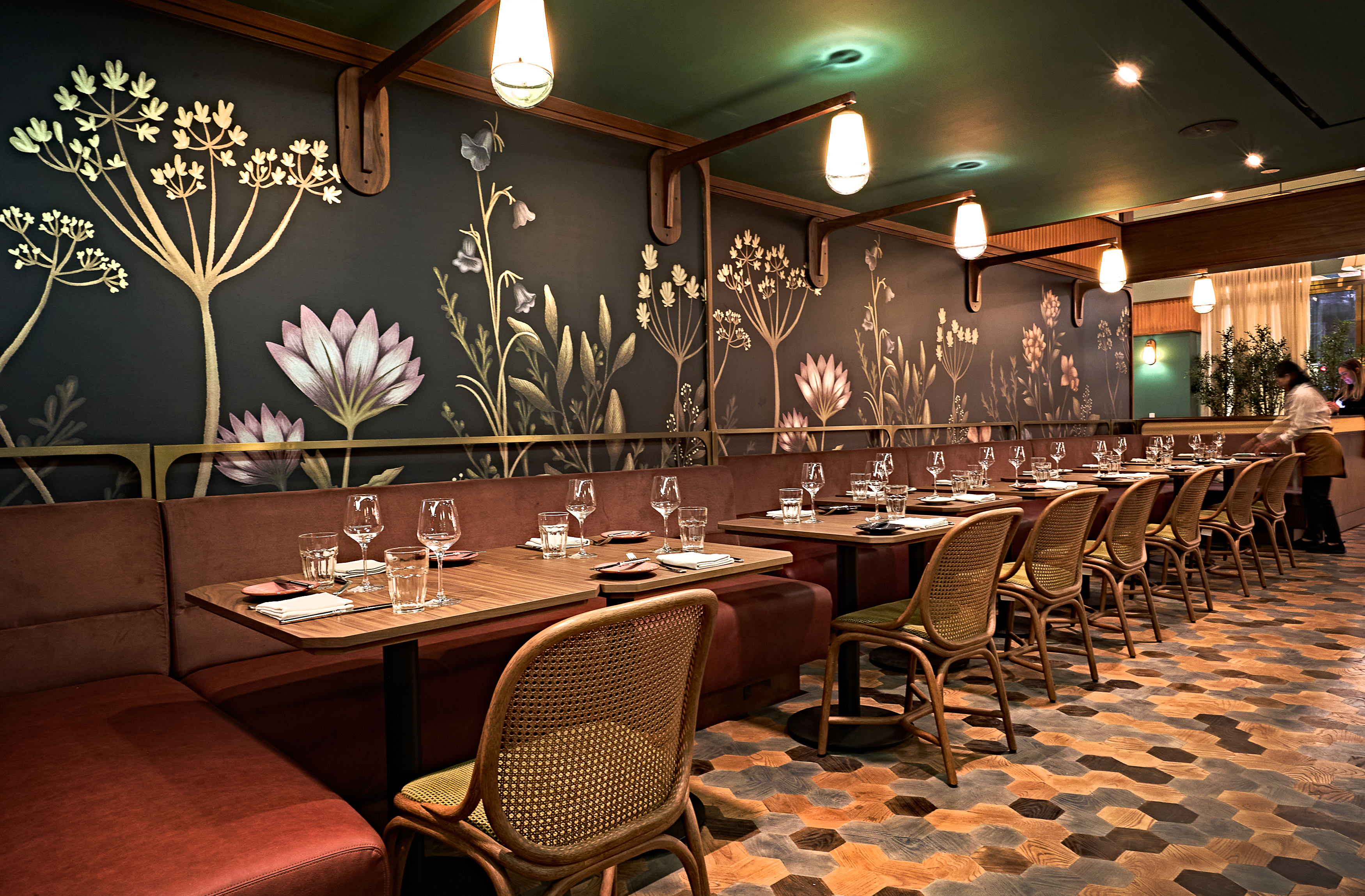 A wallpapered dining room at a newly opened restaurant.
