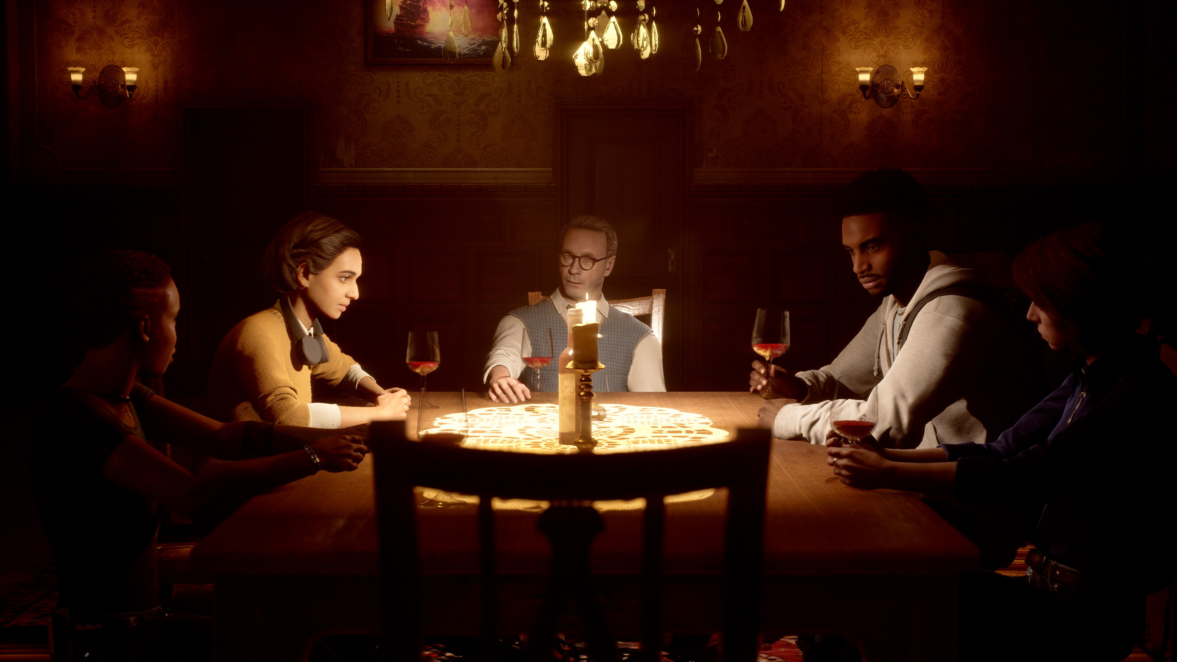 The cast of a true crime show sit in a forbidding dining room, sitting around a table and making conversation, in The Dark Pictures Anthology: The Devil in Me.