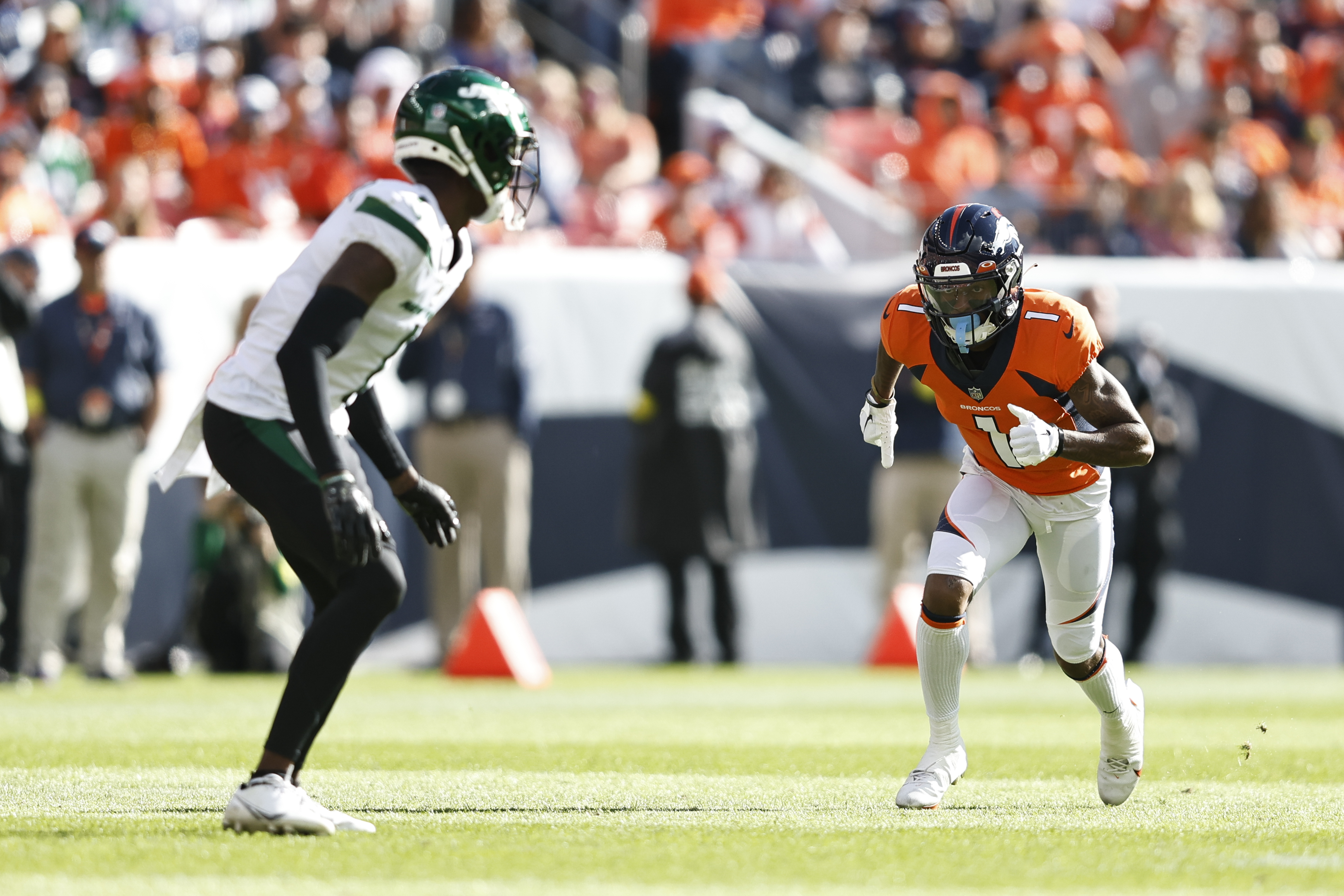 KJ Hamler #1 of the Denver Broncos runs a route against Sauce Gardner #1 of the New York Jets during an NFL football game between the Denver Broncos and the New York Jets at Empower Field At Mile High on October 23, 2022 in Denver, Colorado.
