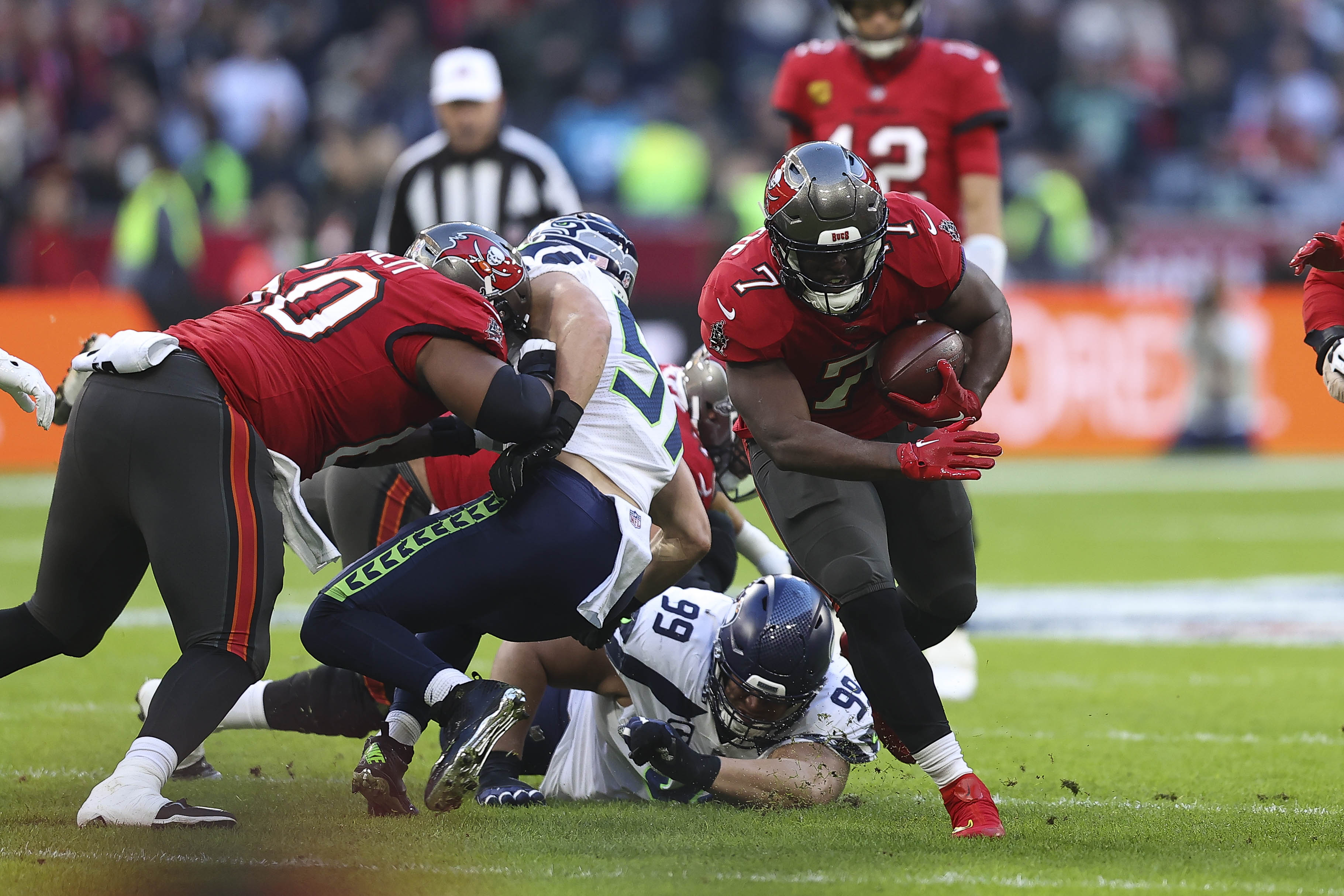 Vita Vea of Tampa Bay Buccaneers, Cody Barton of Seattle Seahawks, Al Woods of Seattle Seahawks and Leonard Fournette of Tampa Bay Buccaneers battle for the ball during the NFL match between Seattle Seahawks&nbsp;and Tampa Bay Buccaneers at Allianz Arena on November 13, 2022 in Munich, Germany.