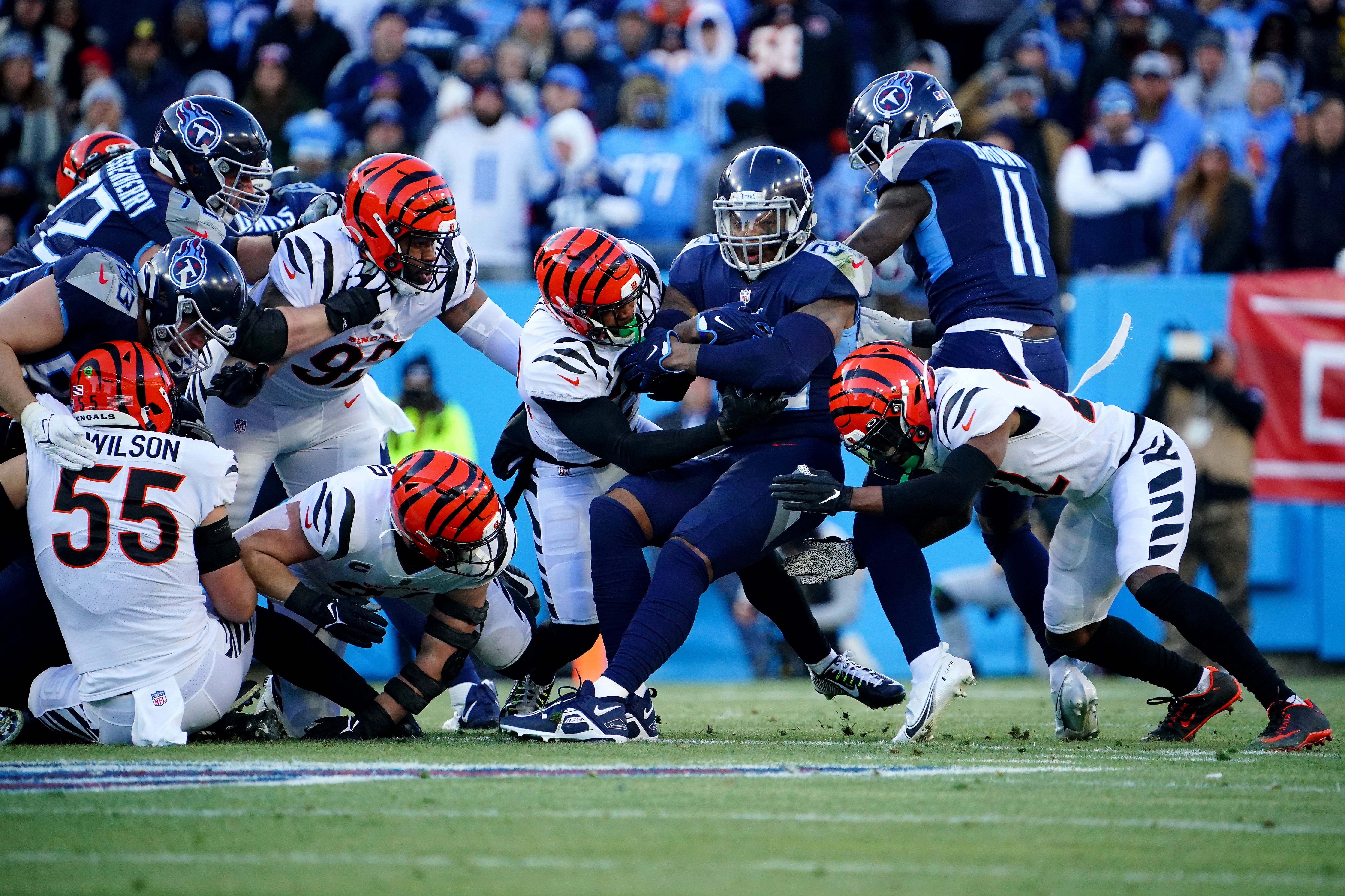 Tennessee Titans running back Derrick Henry (22) is gang tackled by the Cincinnati Bengals defense in the first quarter during an NFL divisional playoff football game