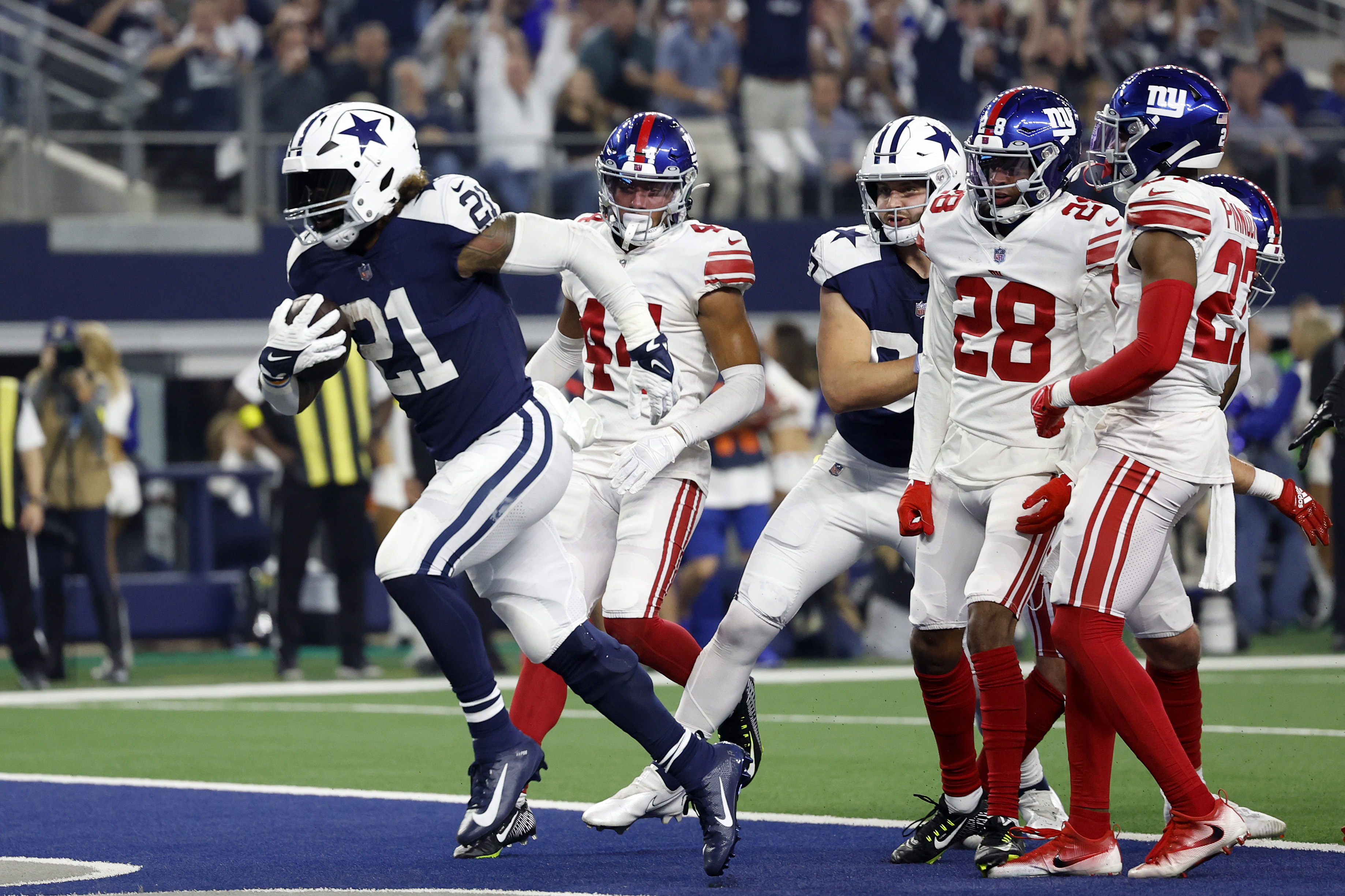 Ezekiel Elliott #21 of the Dallas Cowboys scores a game during the first half in the game against the New York Giants at AT&amp;T Stadium on November 24, 2022 in Arlington, Texas.