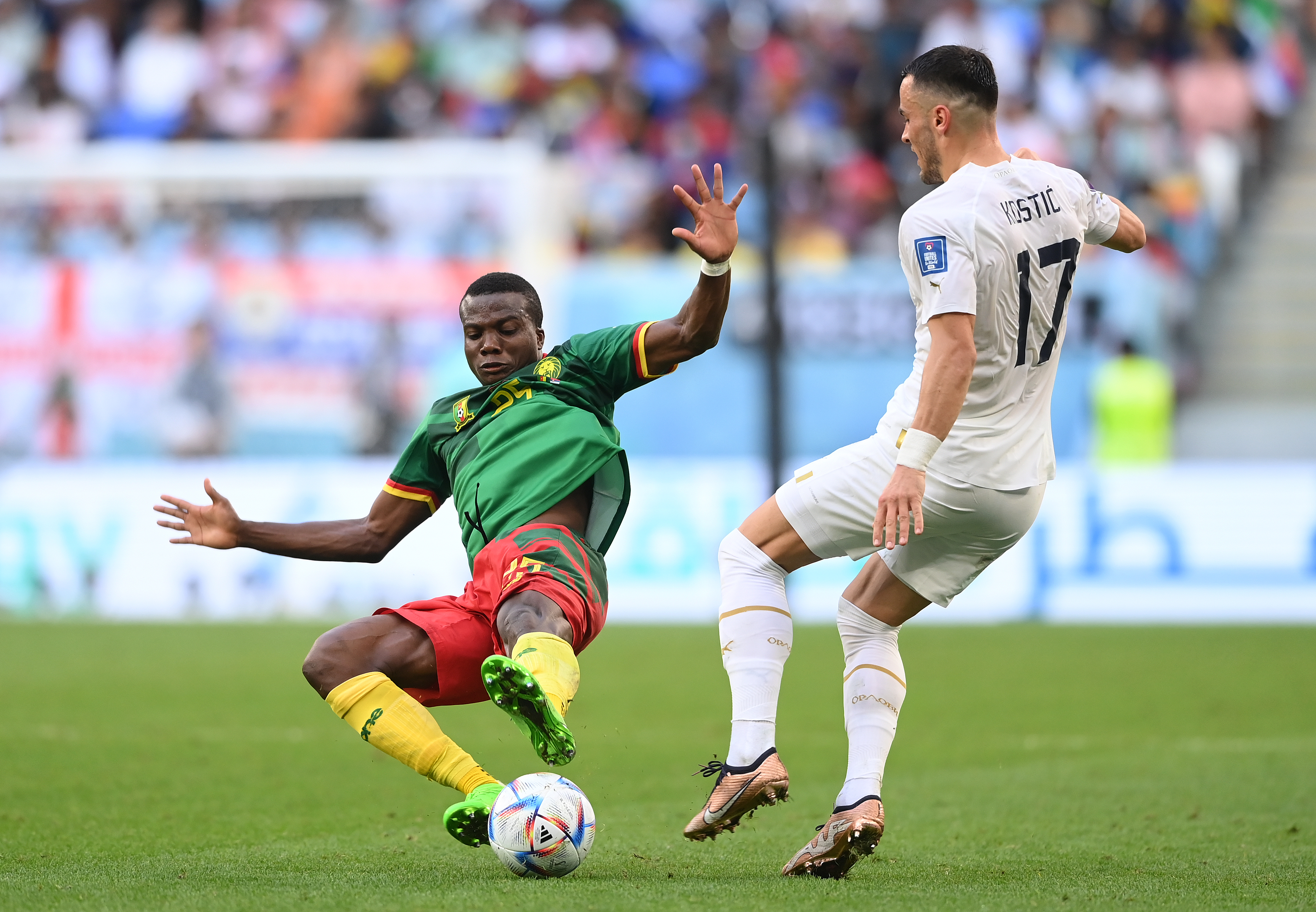 Cameroon v Serbia: Group G - FIFA World Cup Qatar 2022. Nouhou flies in for a tackle against Serbian player Filip Kostic, arms stretched wide and both feet off the ground.