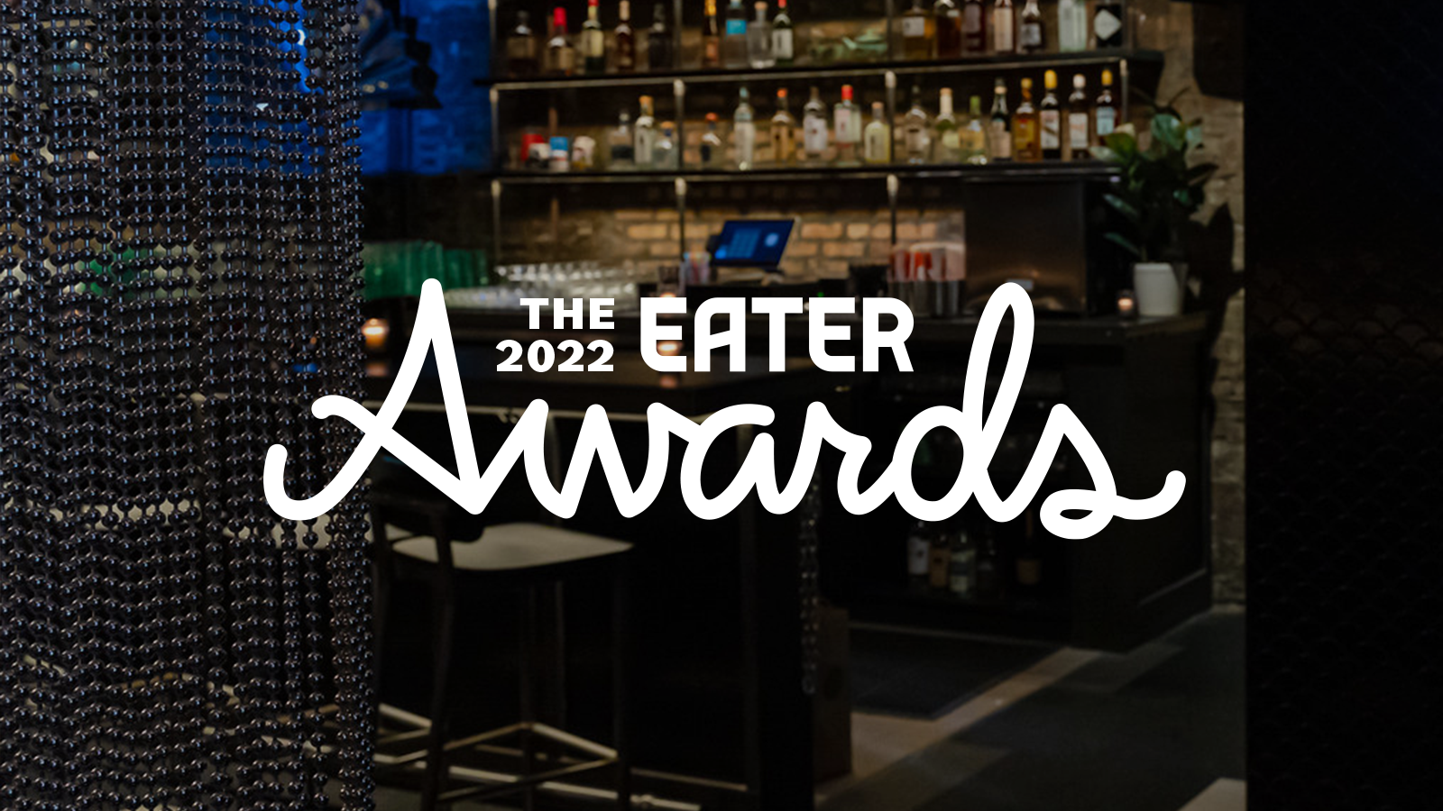 A dim bar with the white text overlay “The 2022 Eater Awards”