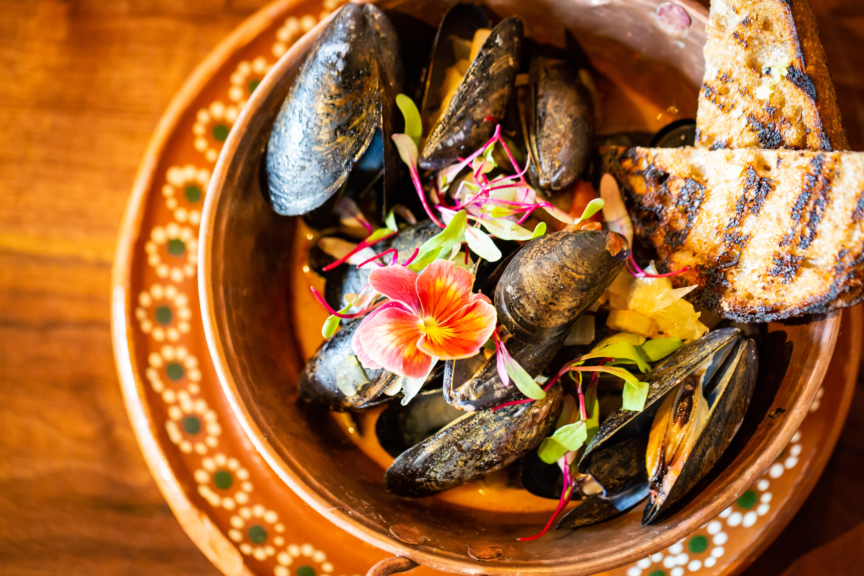 Mejillones or mussels in tomato broth with butter beer and limon confit from Tortuga y Chango in Decatur, GA.