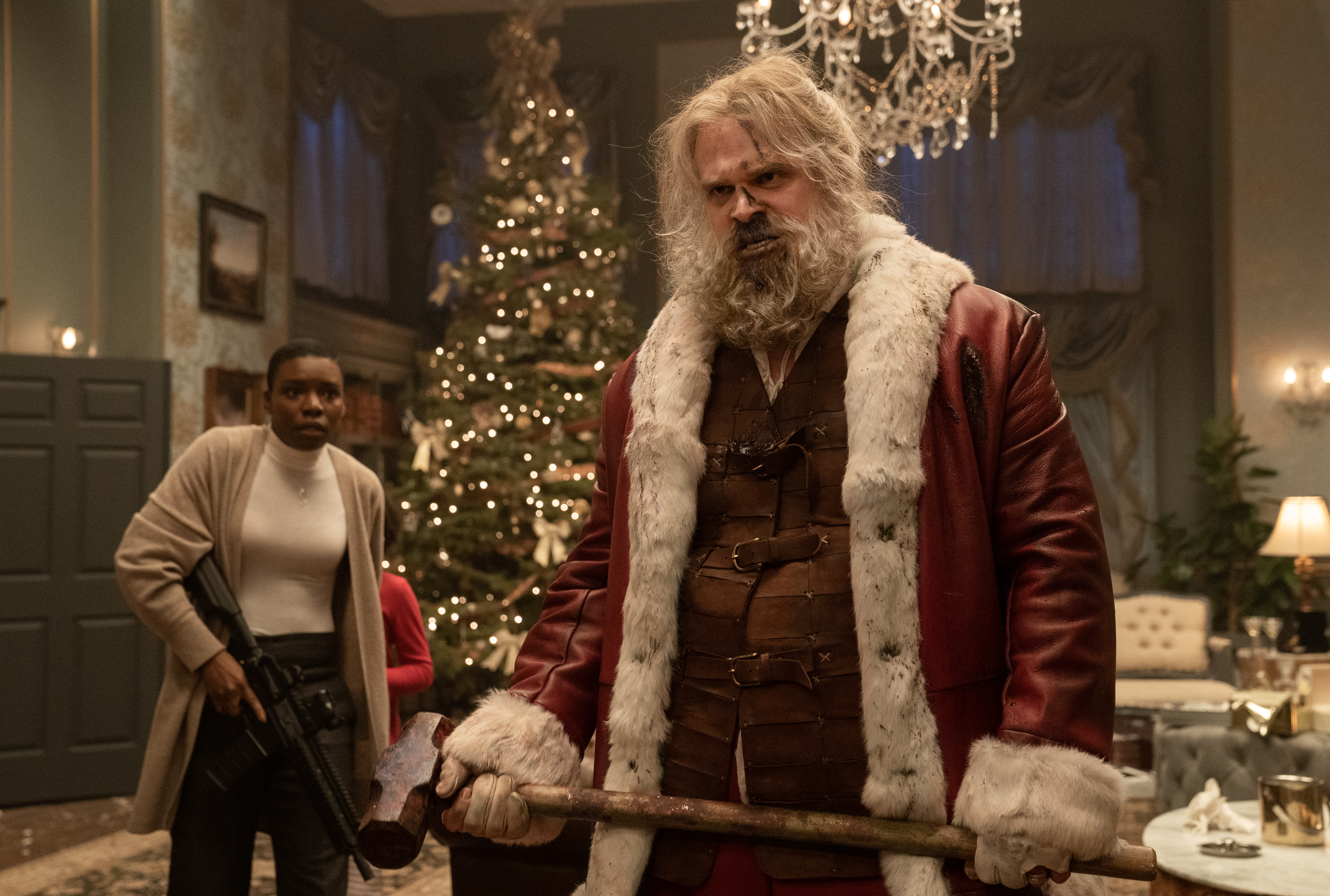 Santa Claus (David Harbour), with a bashed-in, bloody nose, glowers at something off screen in Violent Night