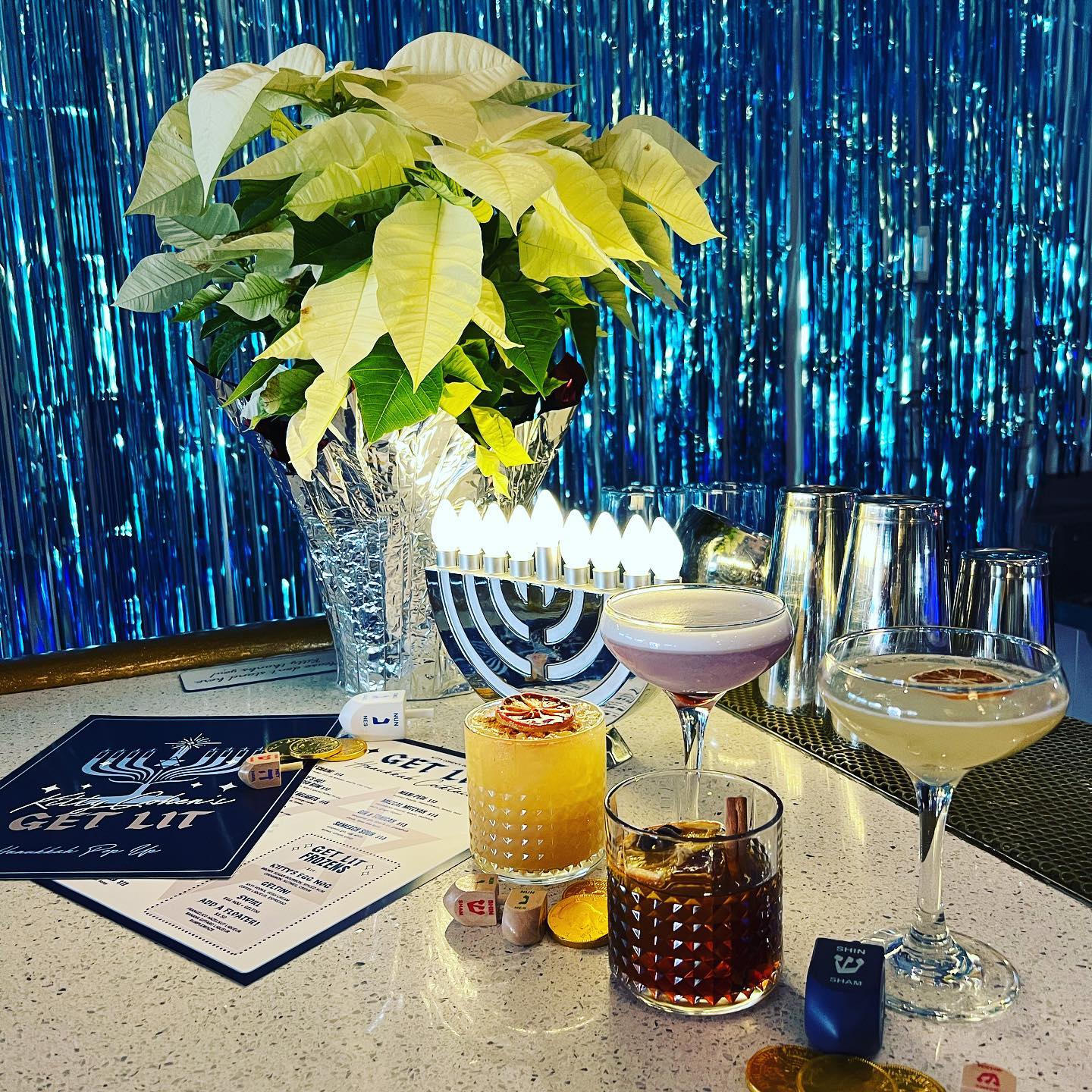 A bar with drinks and a menorah and dreidels.