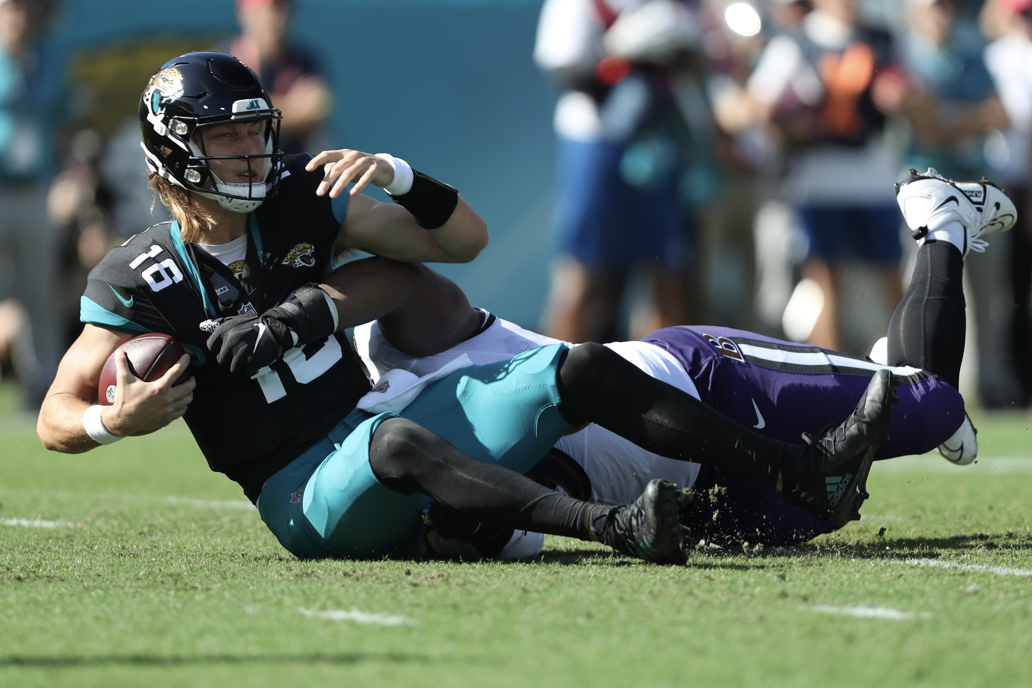 Trevor Lawrence #16 of the Jacksonville Jaguars is sacked by Broderick Washington #96 of the Baltimore Ravens during the first half at TIAA Bank Field on November 27, 2022 in Jacksonville, Florida.