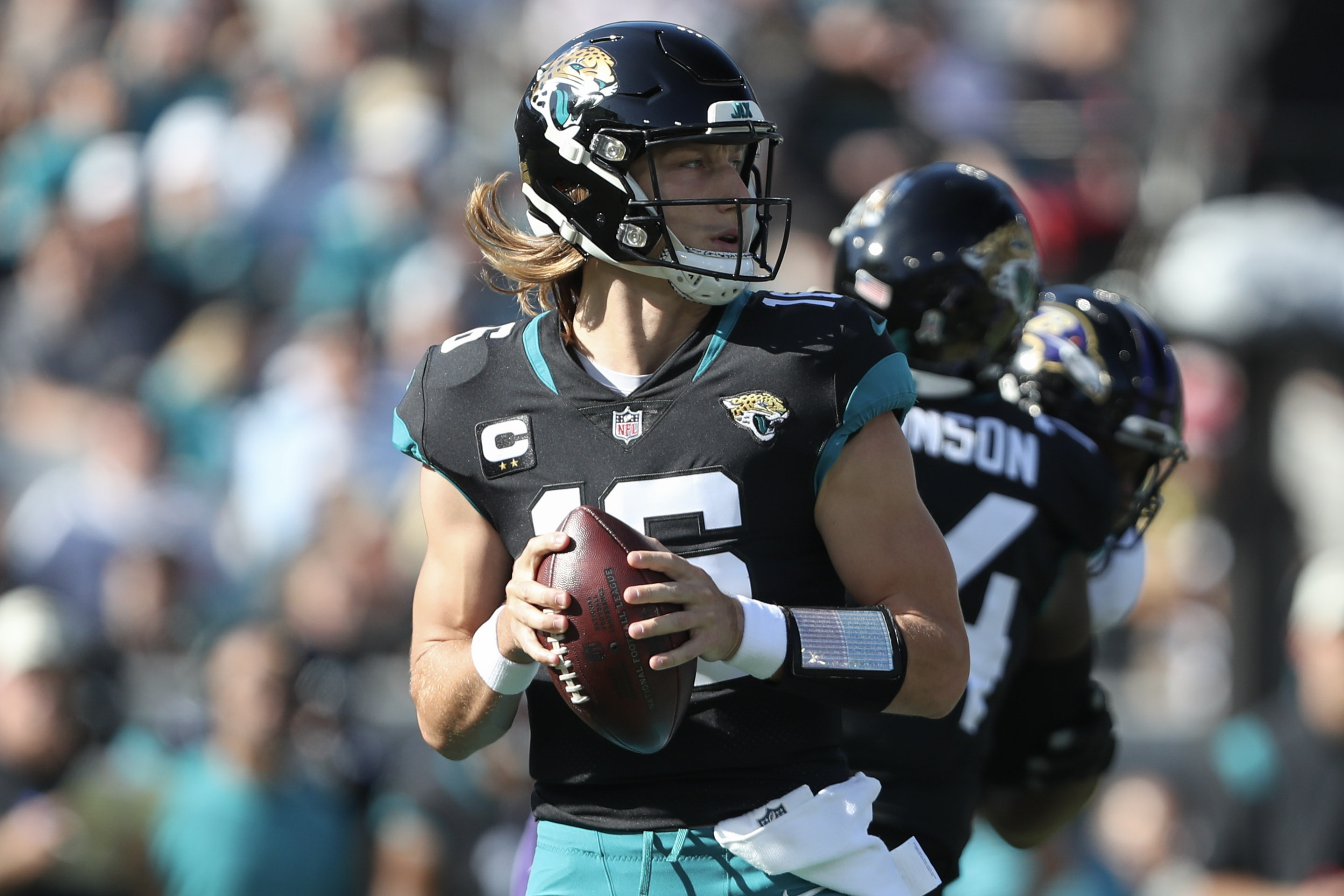 Trevor Lawrence #16 of the Jacksonville Jaguars drops back to pass during the first half against the Baltimore Ravens at TIAA Bank Field on November 27, 2022 in Jacksonville, Florida.