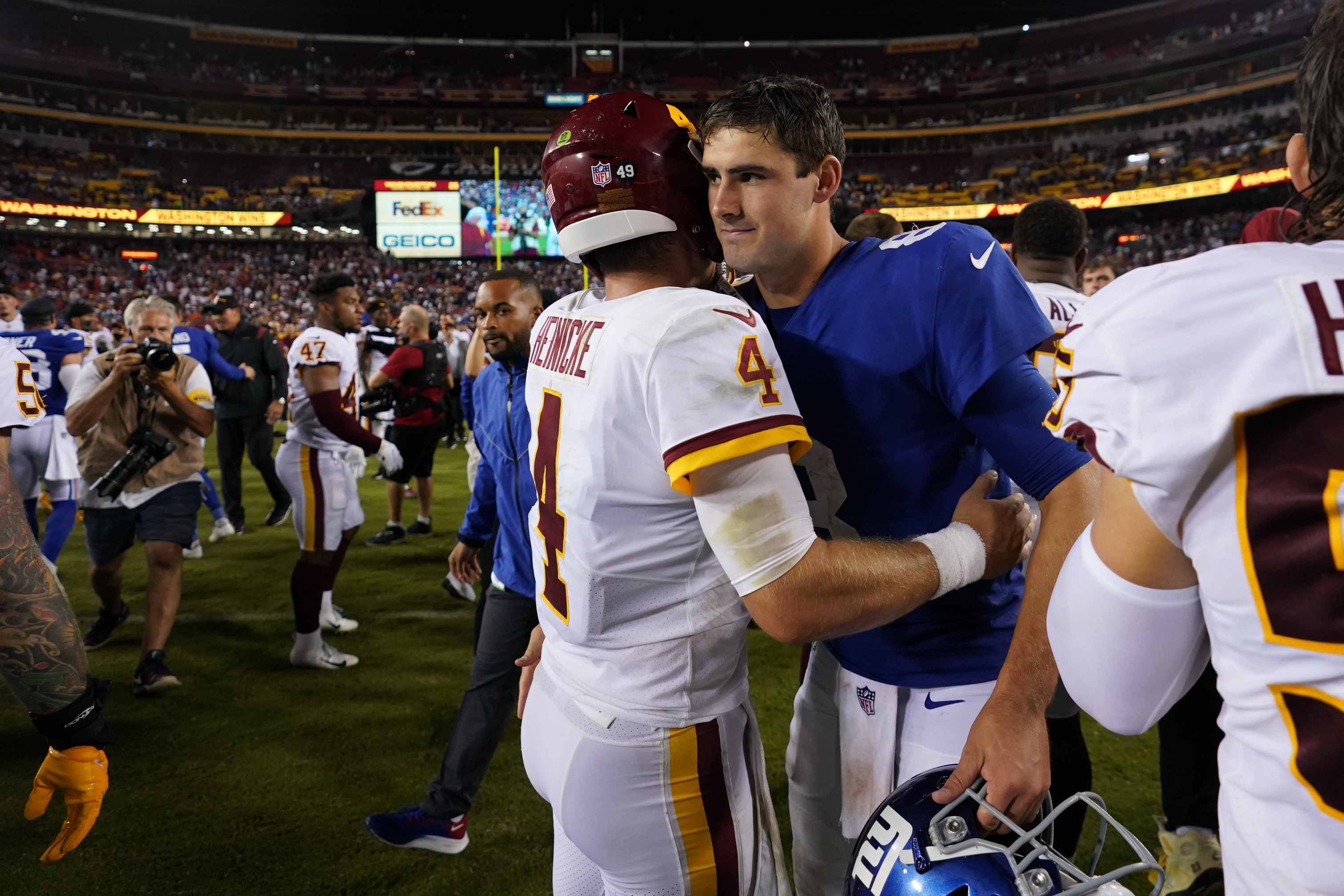 Taylor Heinicke #4 of the Washington Football Team speaks with Daniel Jones #8 of the New York Giants after an NFL game at FedExField on September 16, 2021 in Landover, Maryland.