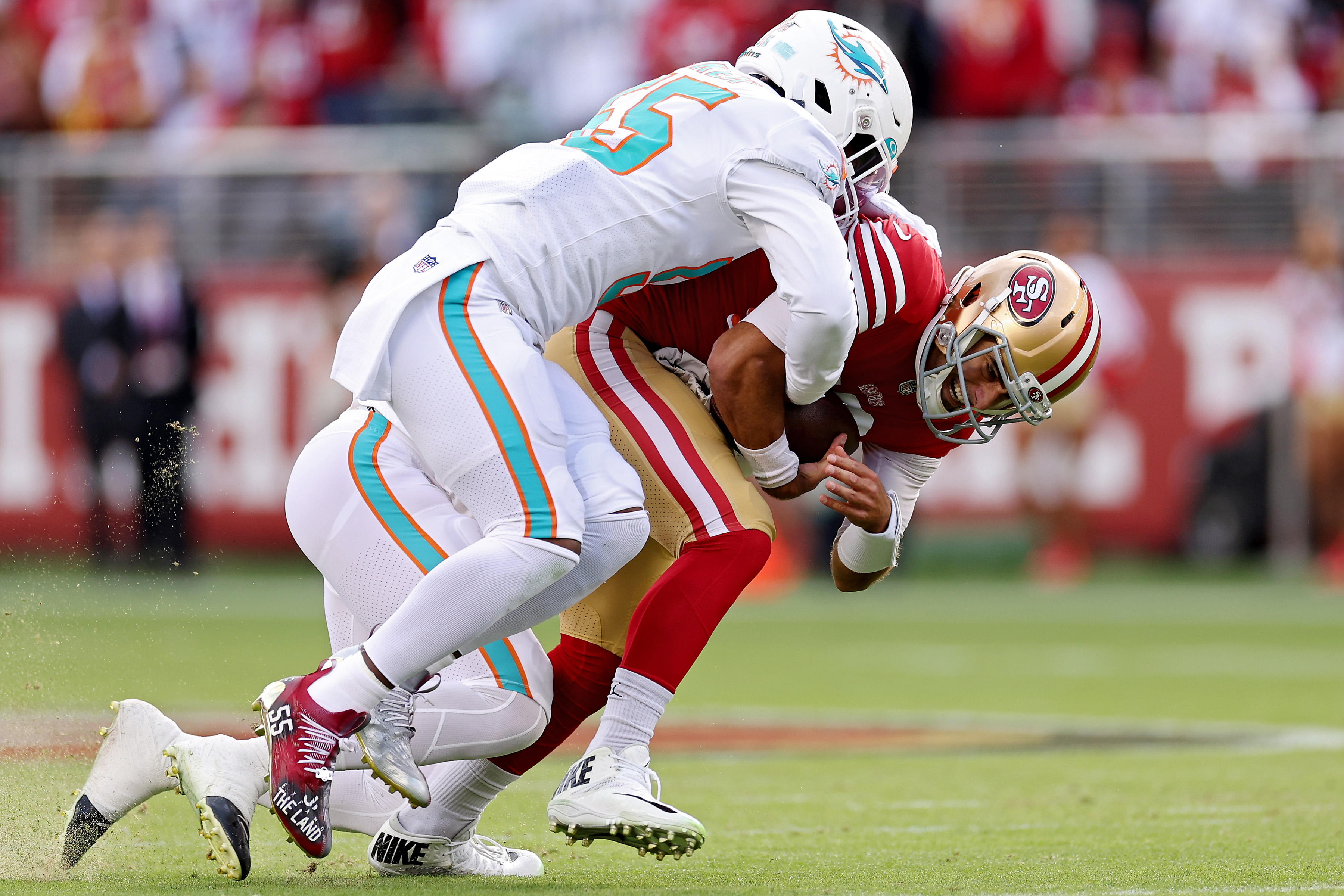 Jaelan Phillips #15 of the Miami Dolphins and Jerome Baker #55 of the Miami Dolphins sack Jimmy Garoppolo #10 of the San Francisco 49ers during the first quarter at Levi’s Stadium on December 04, 2022 in Santa Clara, California.