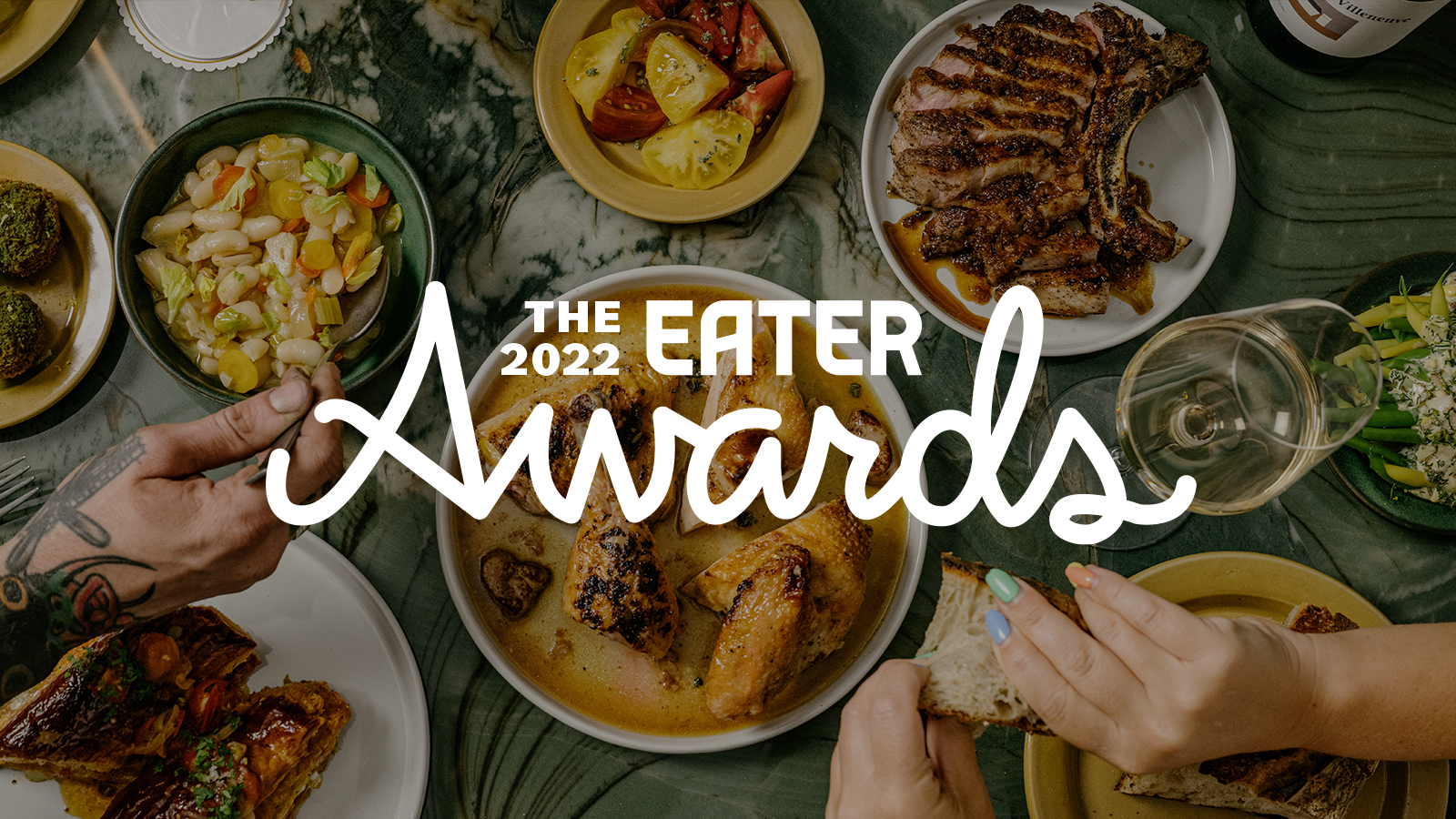 An overhead shot of dishes arranged on a table with the overlay “The 2022 Eater Awards”