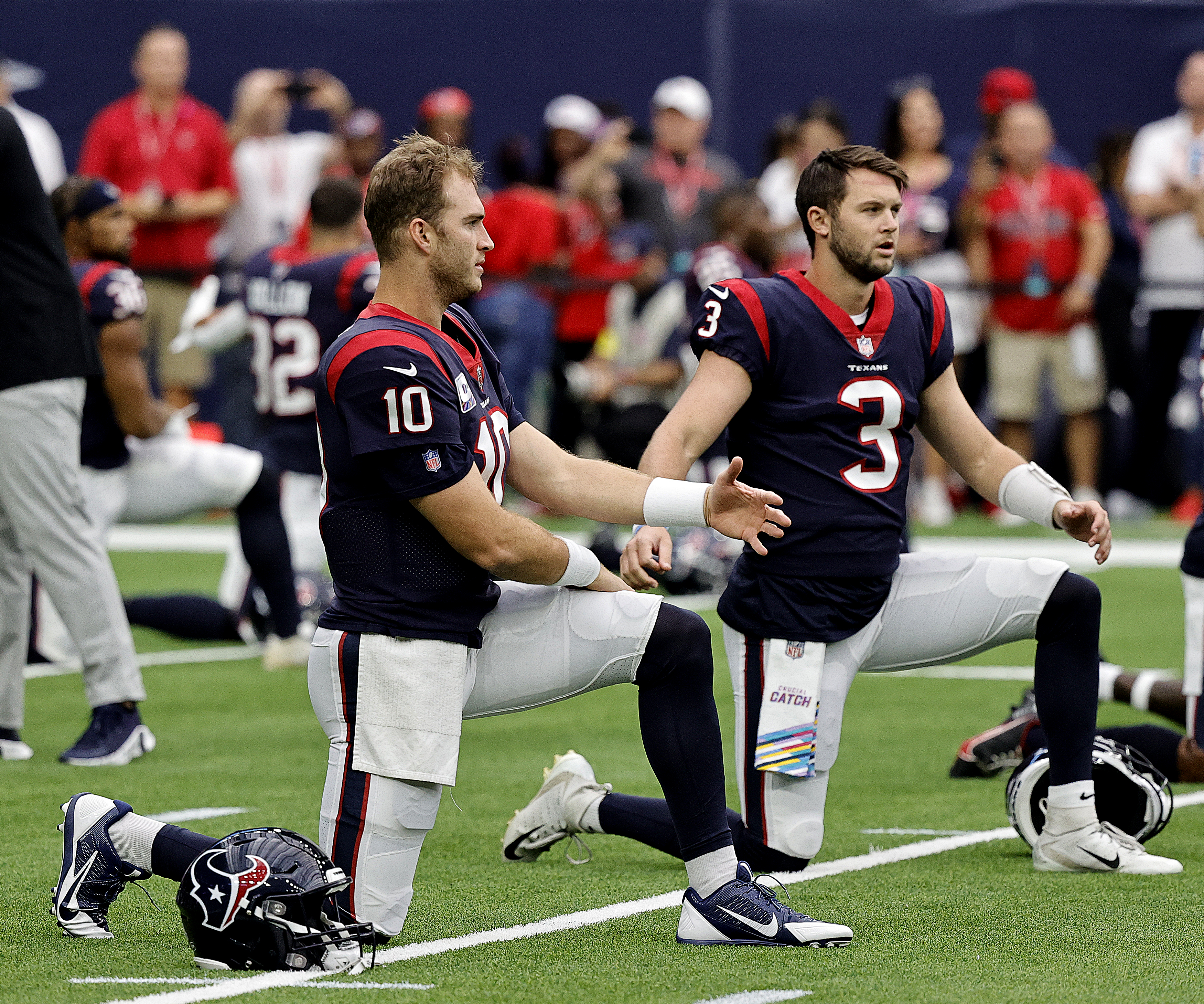 Davis Mills #10 of the Houston Texans and Kyle Allen #3 warms up before a game with the Los Angeles Chargers at NRG Stadium on October 02, 2022 in Houston, Texas.
