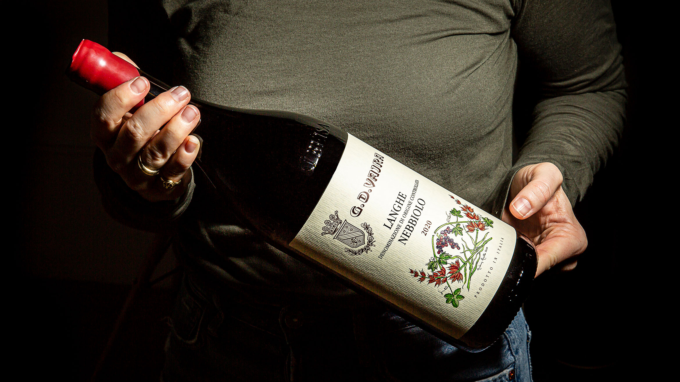 Someone holding a magnum-sized bottle of wine