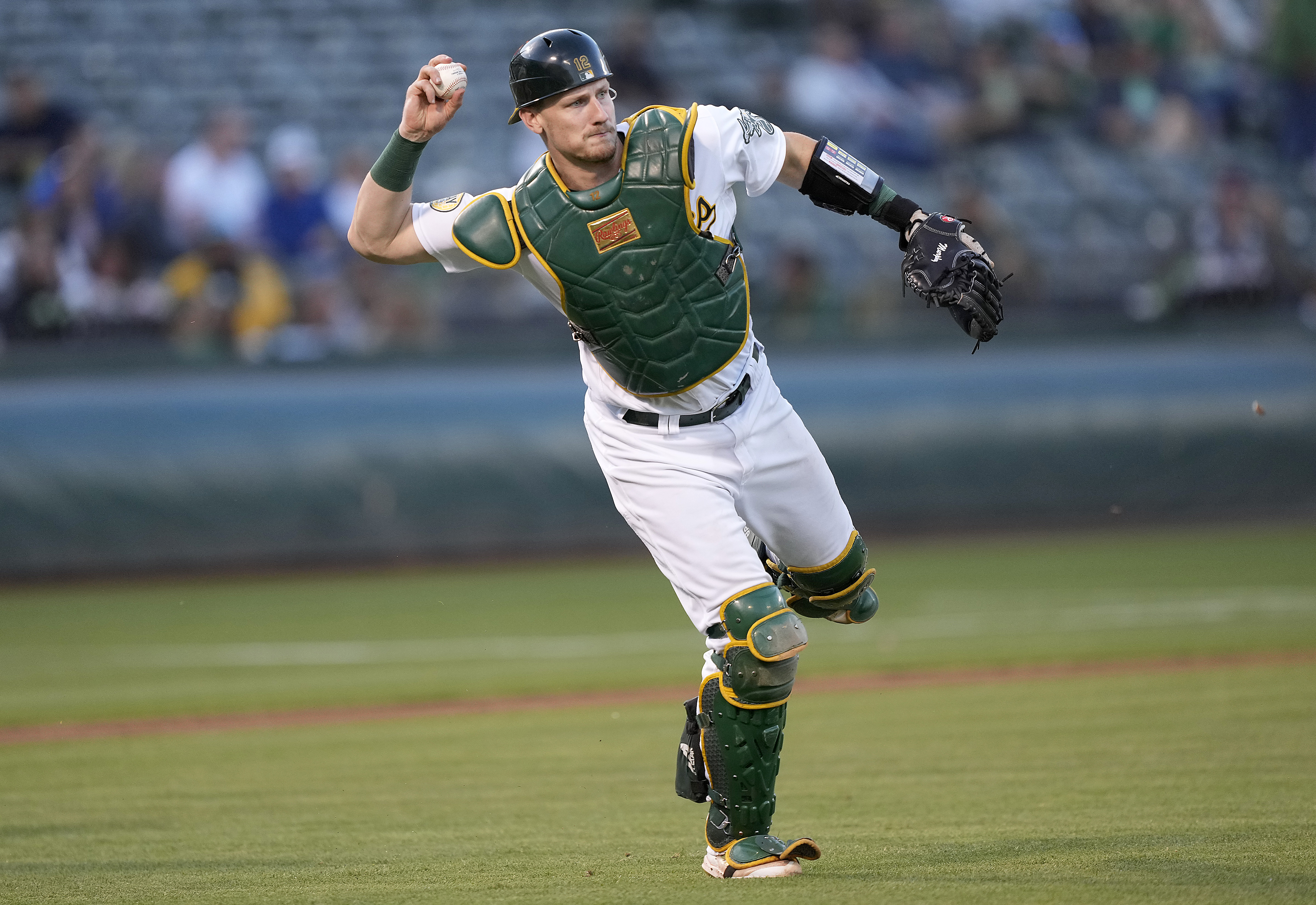 Sean Murphy #12 of the Oakland Athletics throws to first base off balance throwing out JJ Bleday #67 of the Miami Marlins in the top of the third inning at RingCentral Coliseum on August 23, 2022 in Oakland, California.