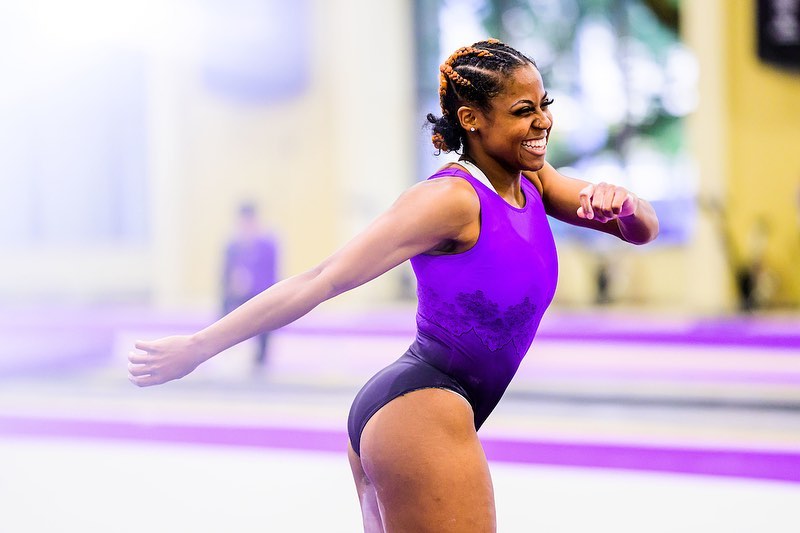 LSU gymnast Cammy Hall smiling while running through her floor routine at the LSU Gymnastics Training Facility