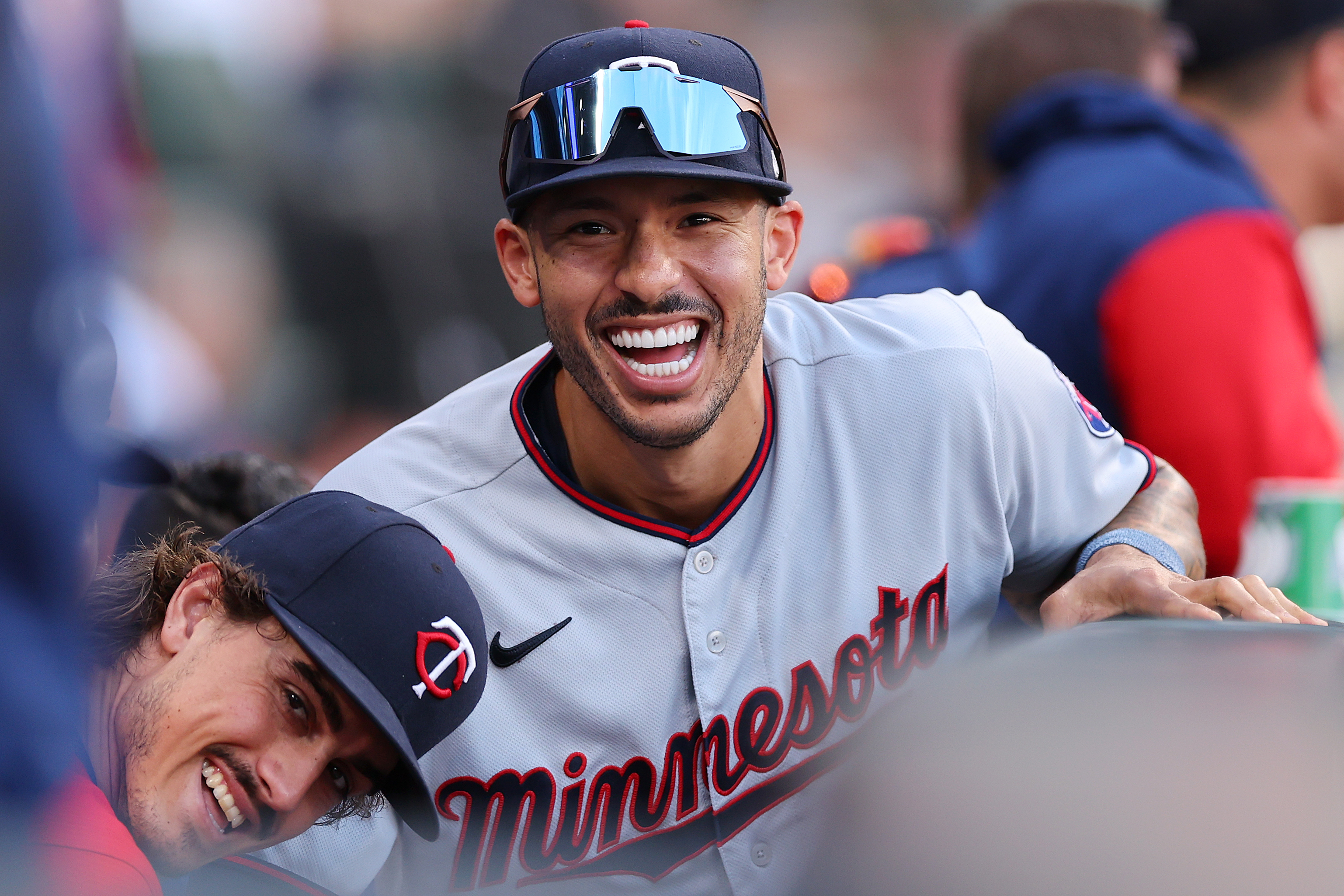 Carlos Correa smiles in the Twins dugout