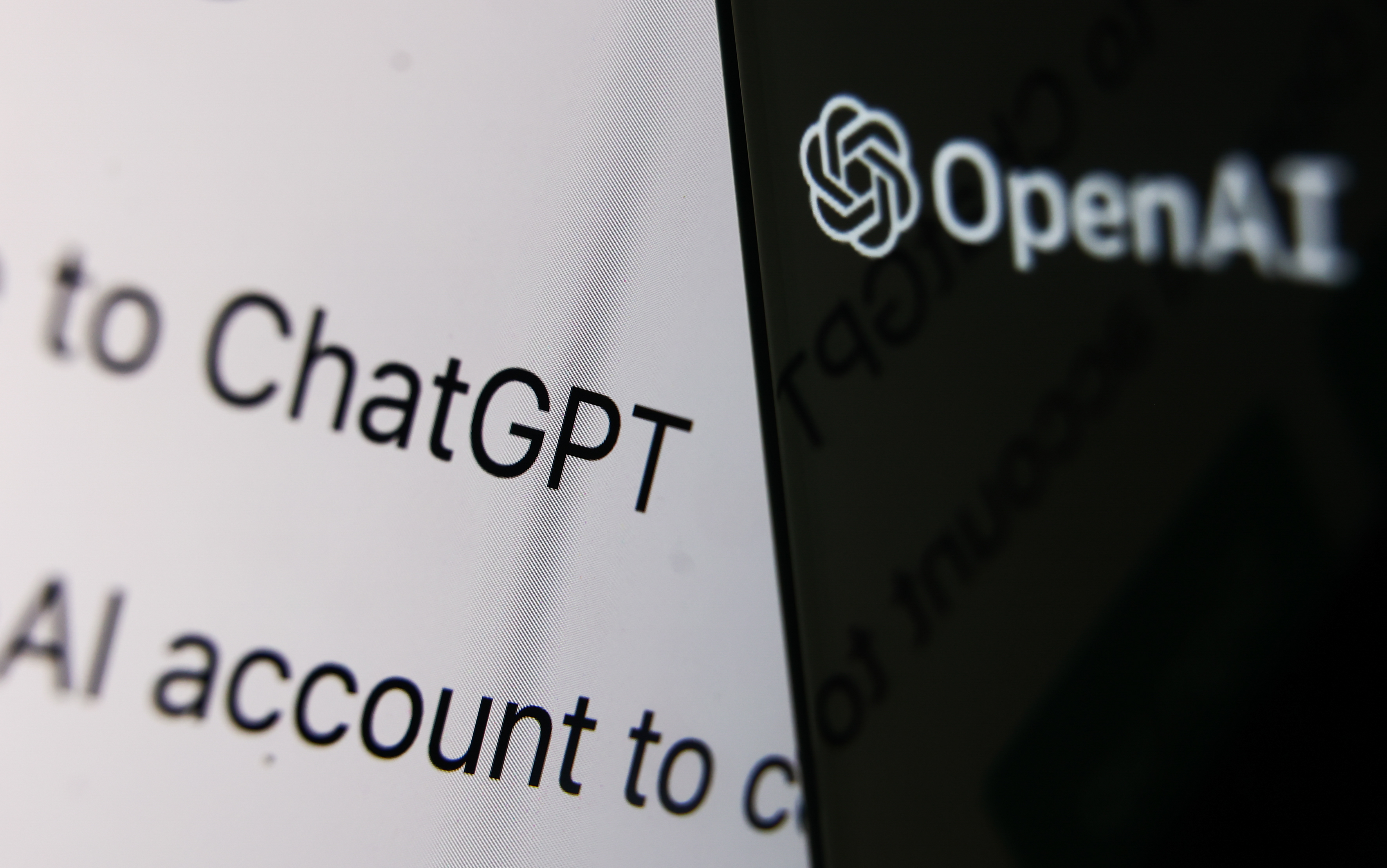 OpenAI logo displayed on a phone screen and ChatGPT website displayed on a laptop screen are seen in this illustration photo taken in Krakow, Poland on December 5, 2022