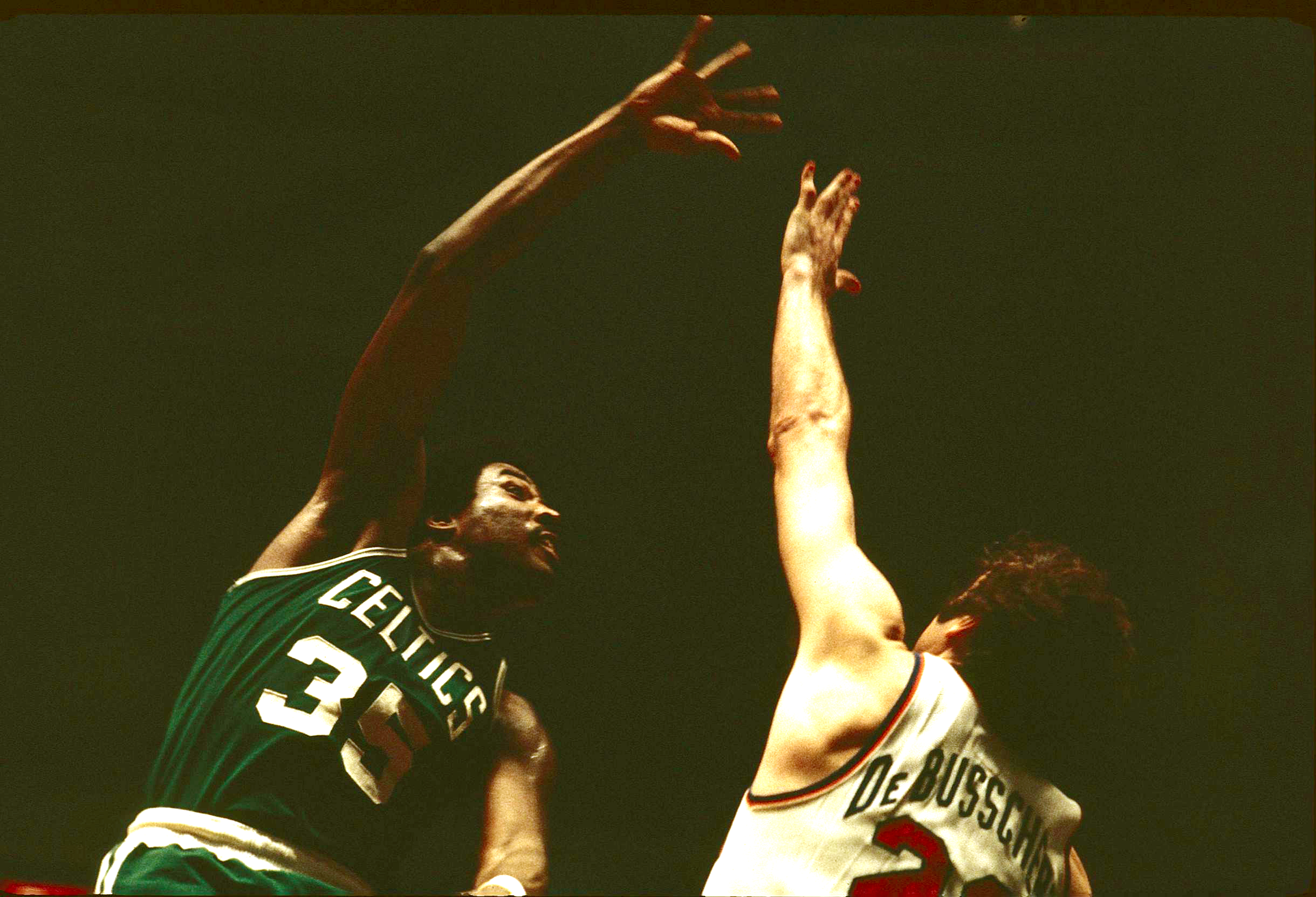 Paul Silas of the Boston Celtics, shoots while being guarded by Dave DeBusschere of the New York Knicks